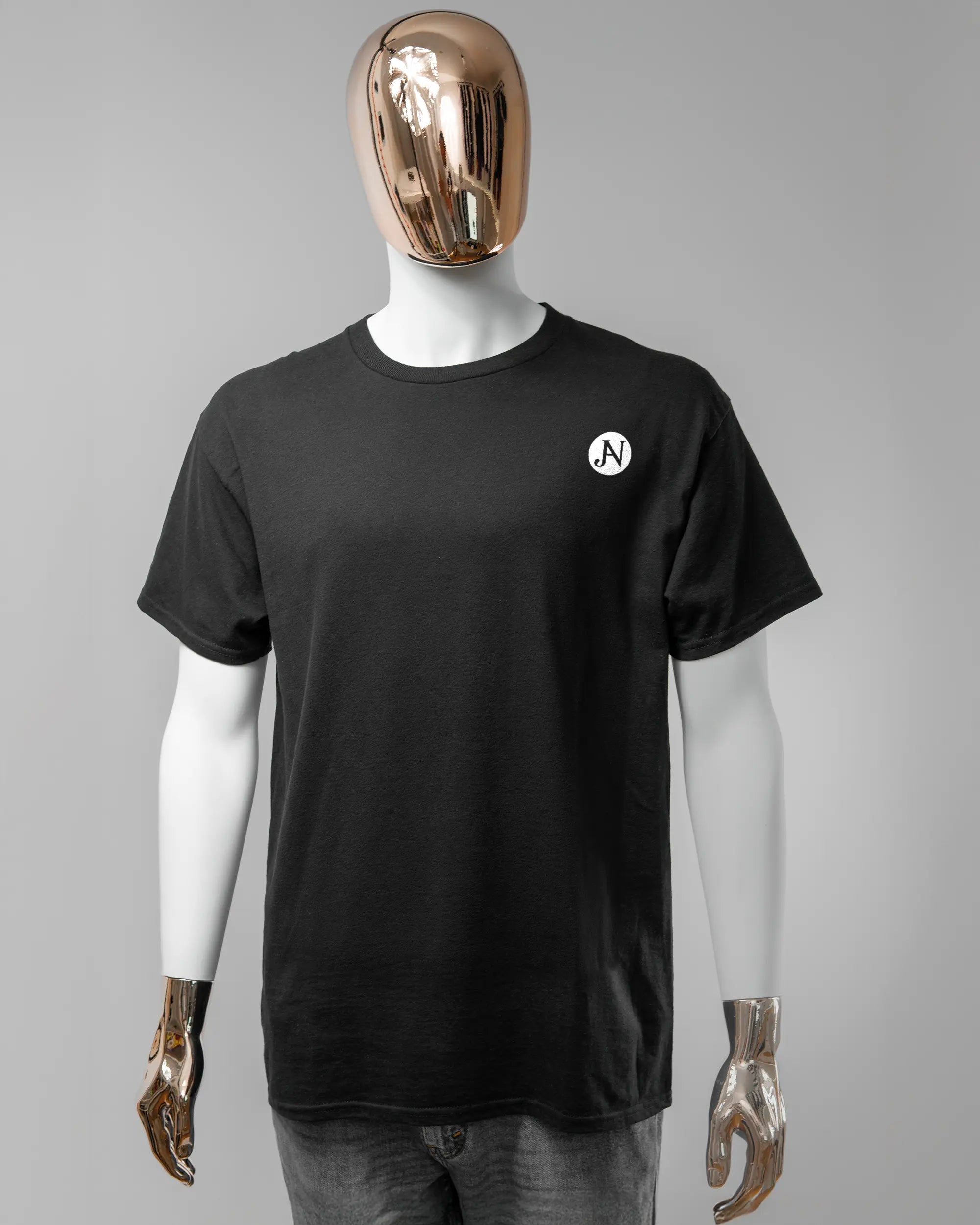 Vorderseite des Basic Unisex T-Shirt Regular von Maondo mit dem Design JB1 in der Farbe Black und in der Größe L getragen von einer maskulinen Puppe
