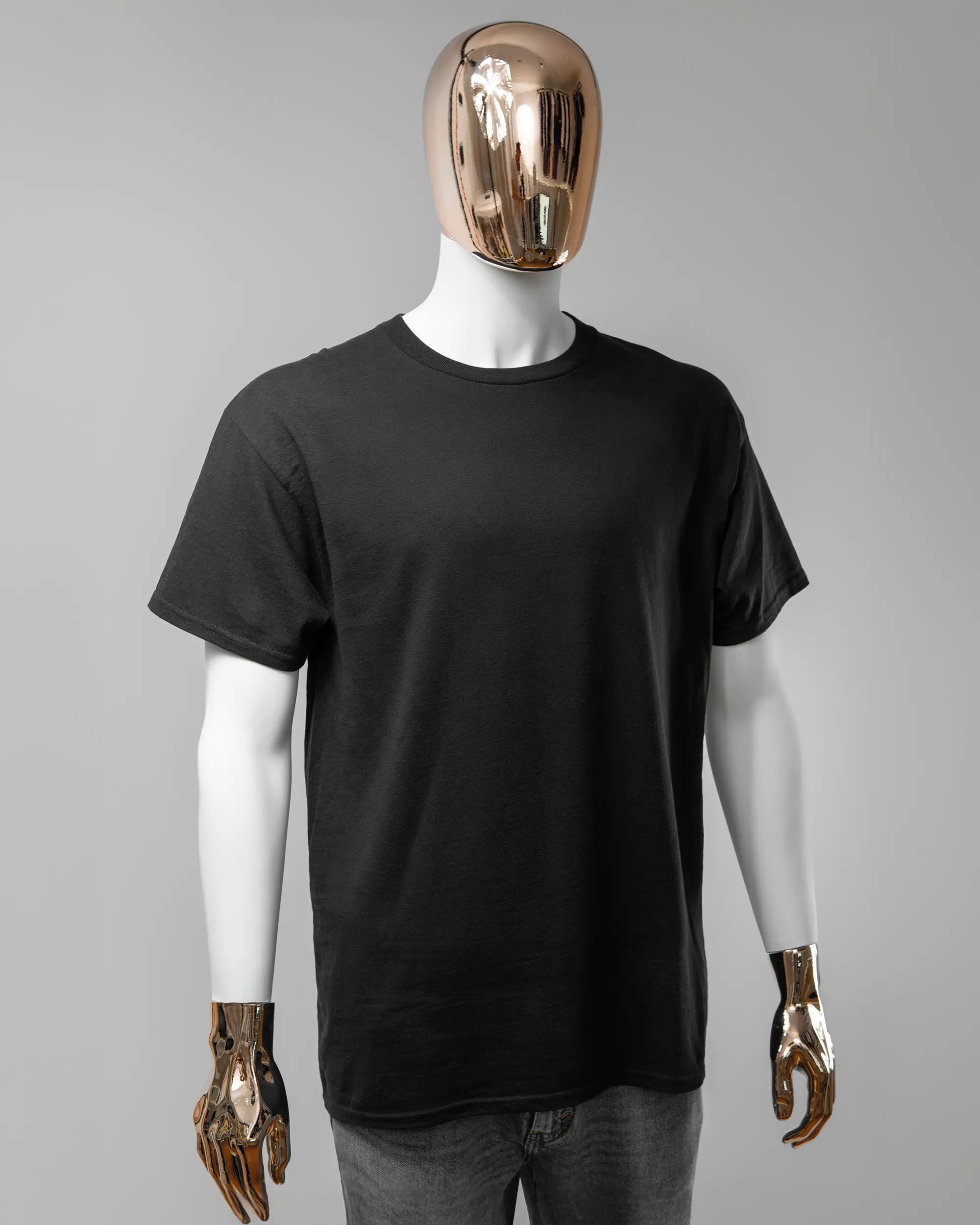 Vorderseite des Basic Unisex T-Shirt Regular von Maondo ohne Motiv in der Farbe Black und in der Größe L getragen von einer maskulinen Puppe