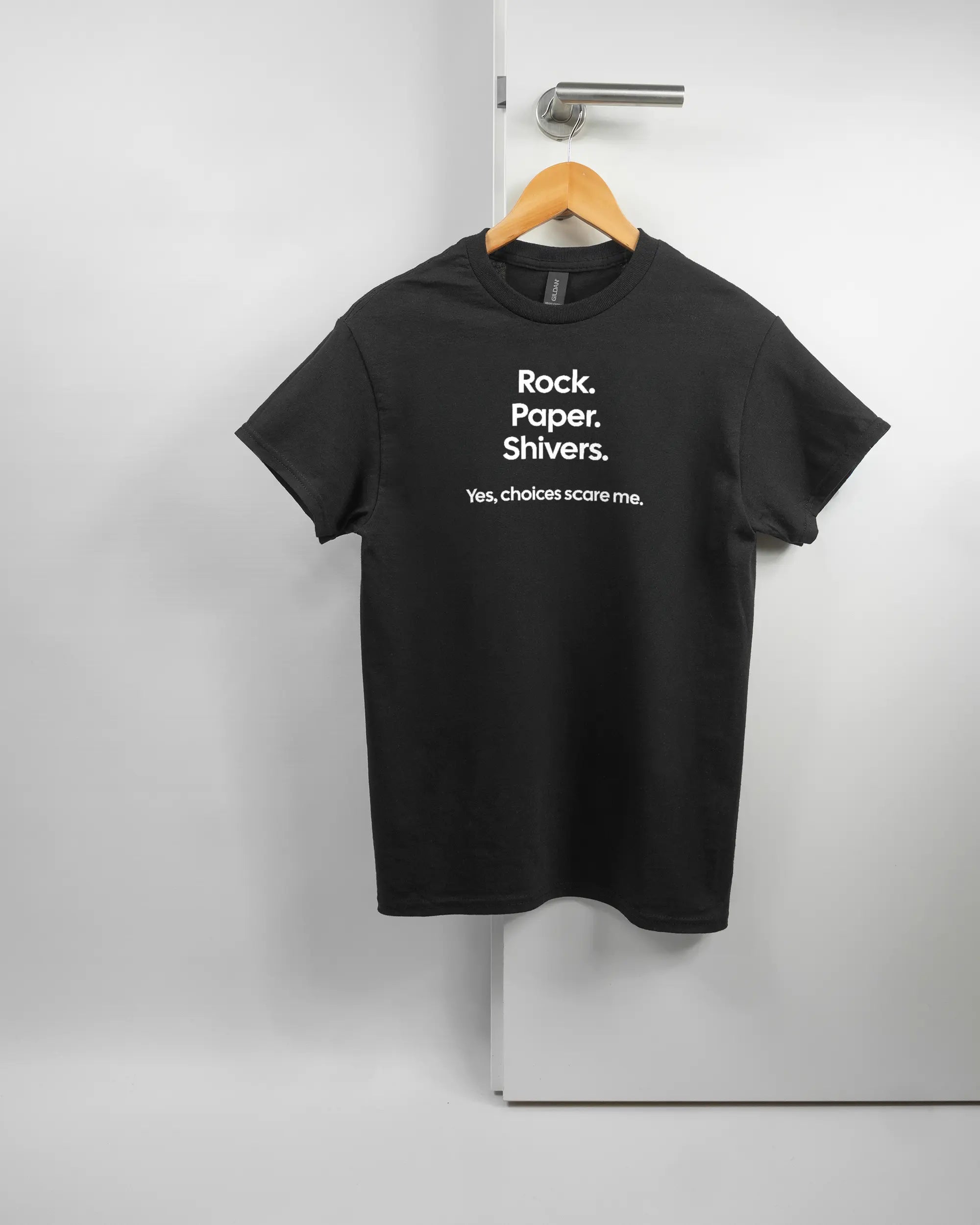 Vorderseite des Basic Unisex T-Shirt Regular von Maondo mit dem Design Rock Paper Shivers in der Farbe Black und in der Größe S auf einem Bügel an der Türklinke aufgehängt