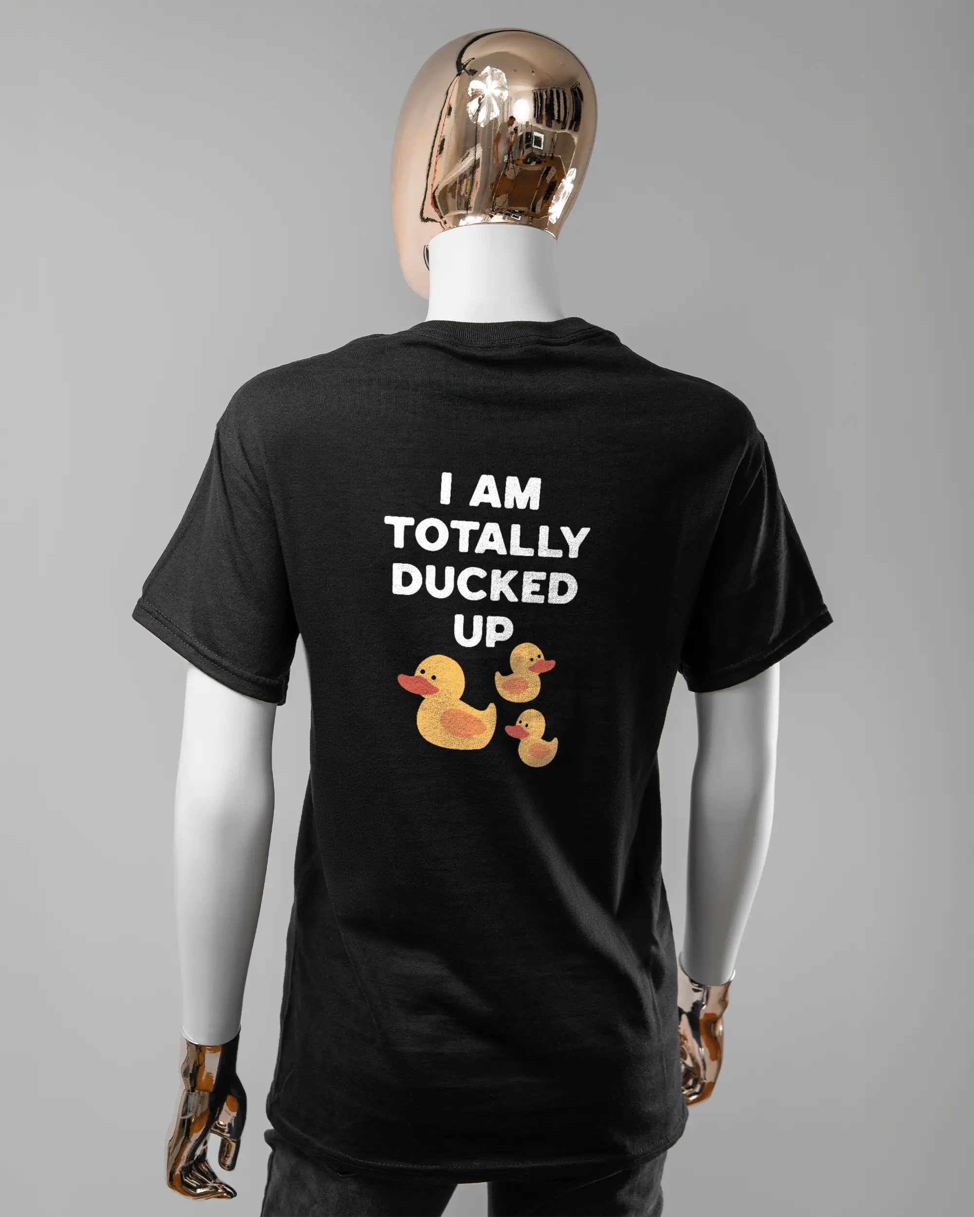 Rückseite des Basic Unisex T-Shirt Regular von Maondo mit dem Design Ducked Up in der Farbe Black und in der Größe S getragen von einer femininen Puppe