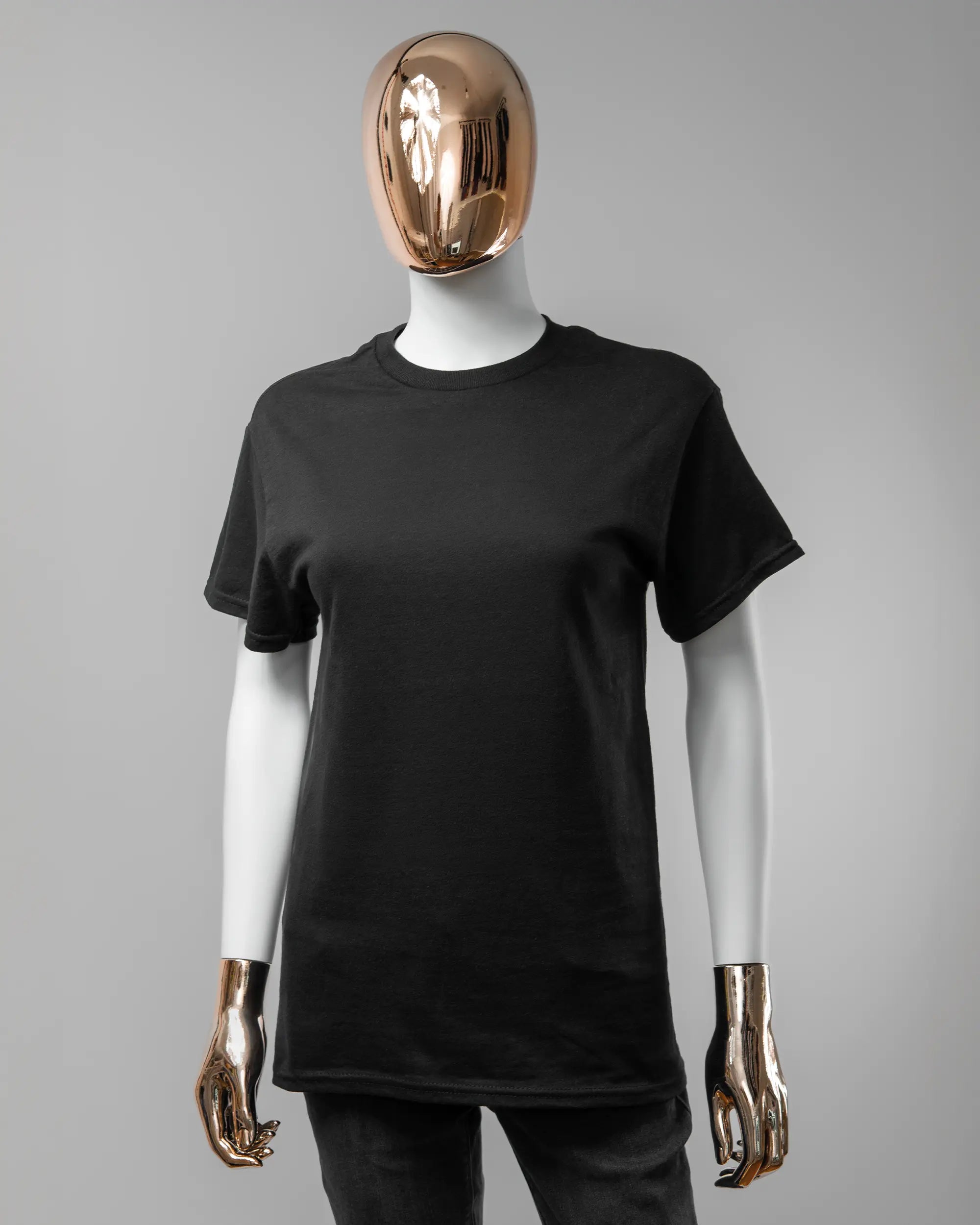 Vorderseite des Basic Unisex T-Shirt Regular von Maondo ohne Motiv in der Farbe Black und in der Größe S getragen von einer femininen Puppe