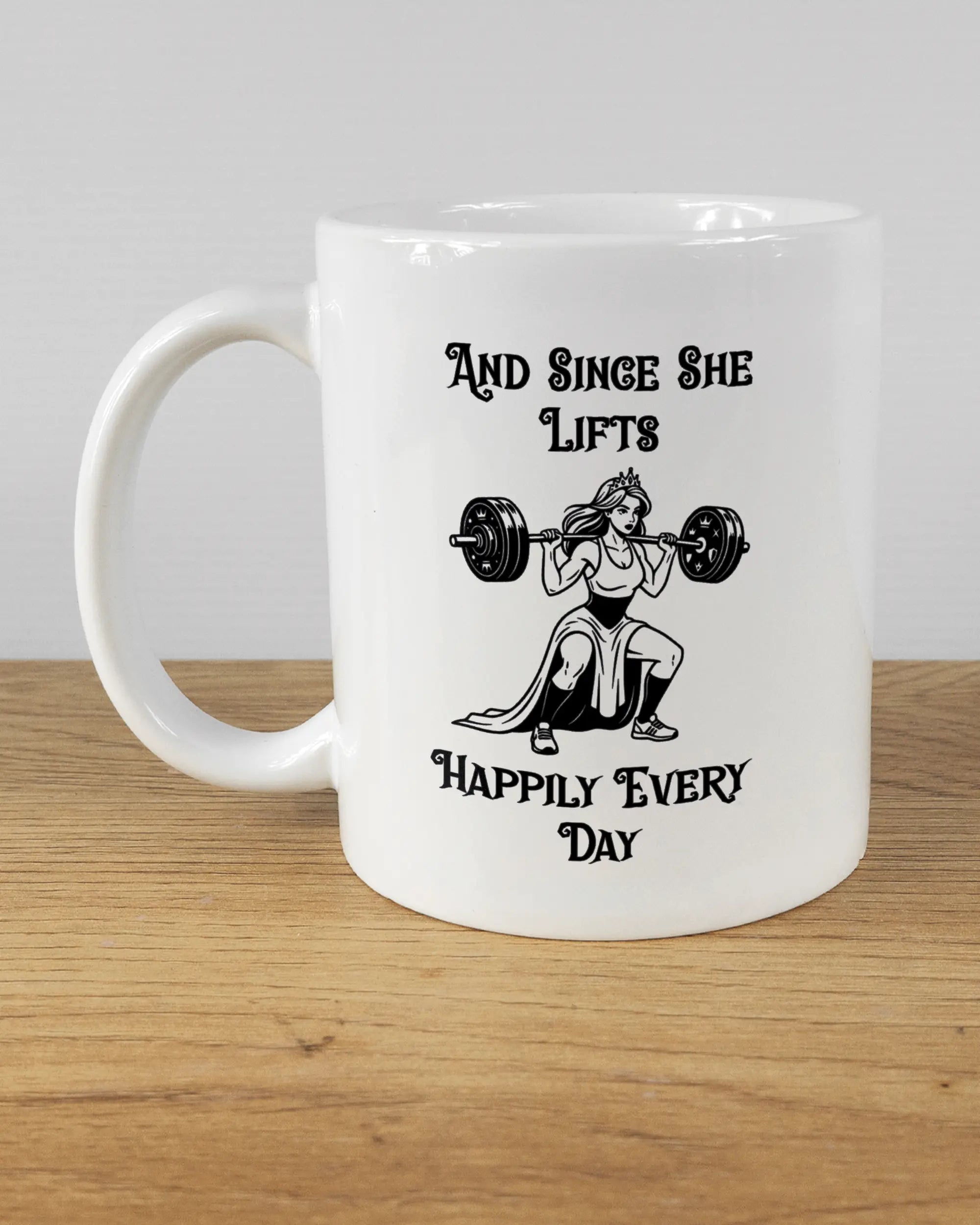 Titelbild, das die linke Seite der beidseitig bedruckten Keramiktasse von Maondo mit dem Design Princess Lift in der Farbe White auf einem Holztisch zeigt