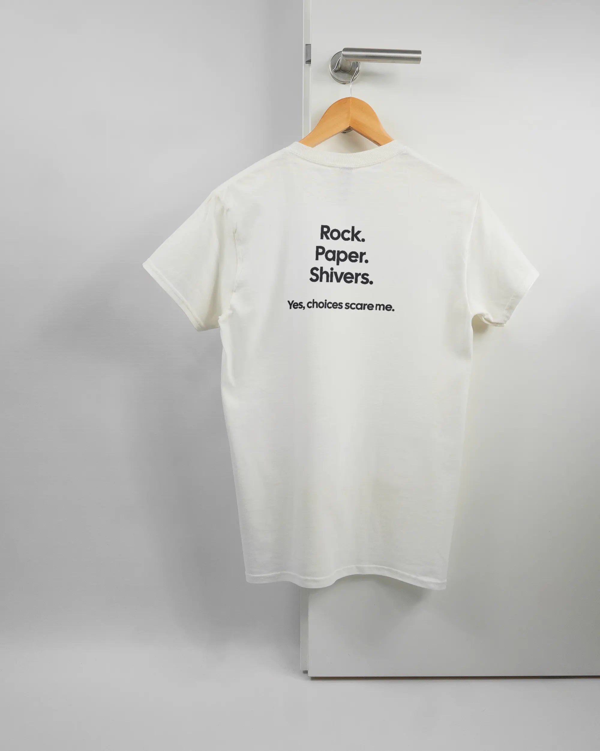 Rückseite des Basic Unisex T-Shirt Regular von Maondo mit dem Design Rock Paper Shivers in der Farbe White und in der Größe S auf einem Bügel an der Türklinke aufgehängt