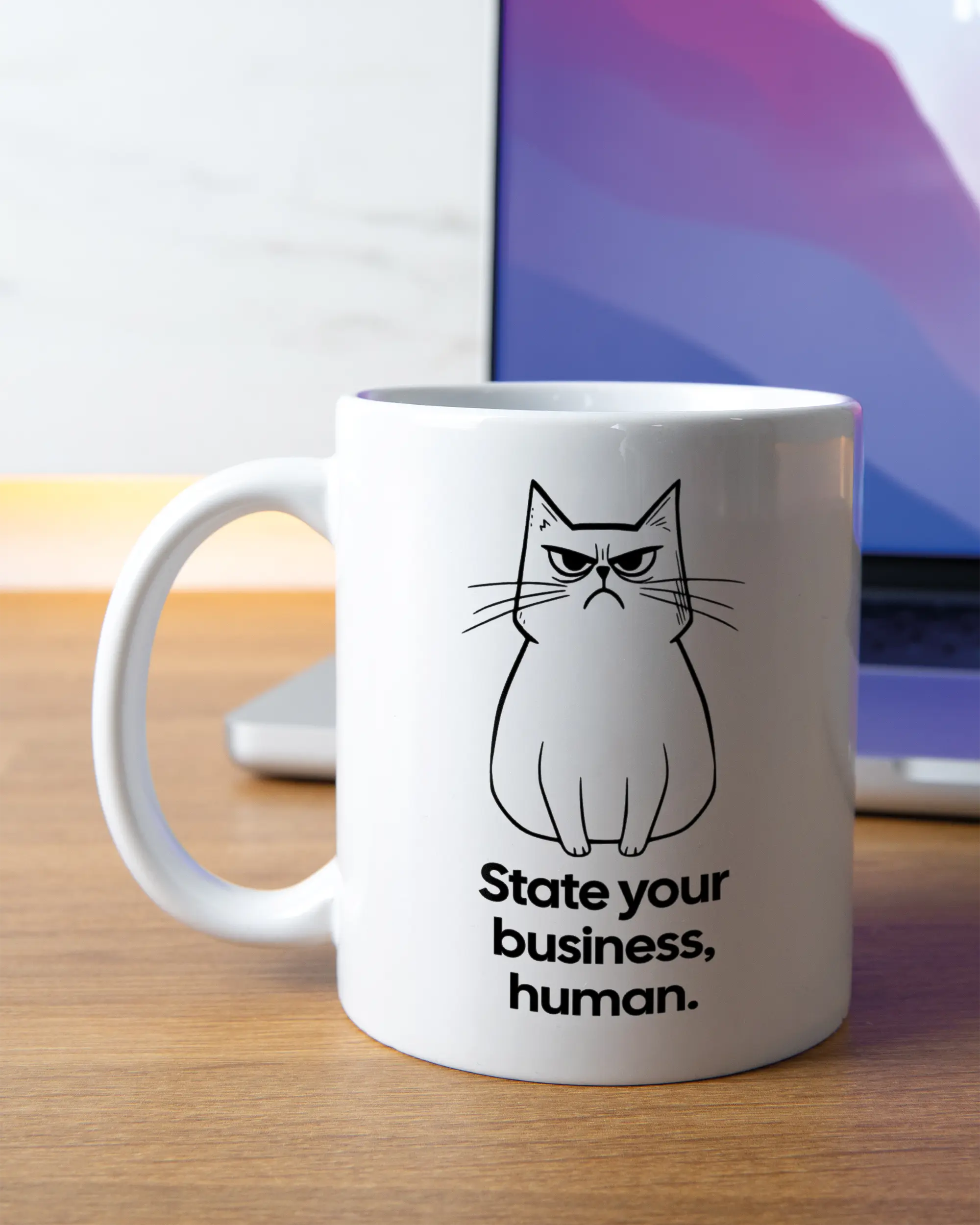 Homeoffice Aufnahme der linken Seite der beidseitig bedruckten Keramiktasse von Maondo mit dem Design Grumpy Purr in der Farbe White