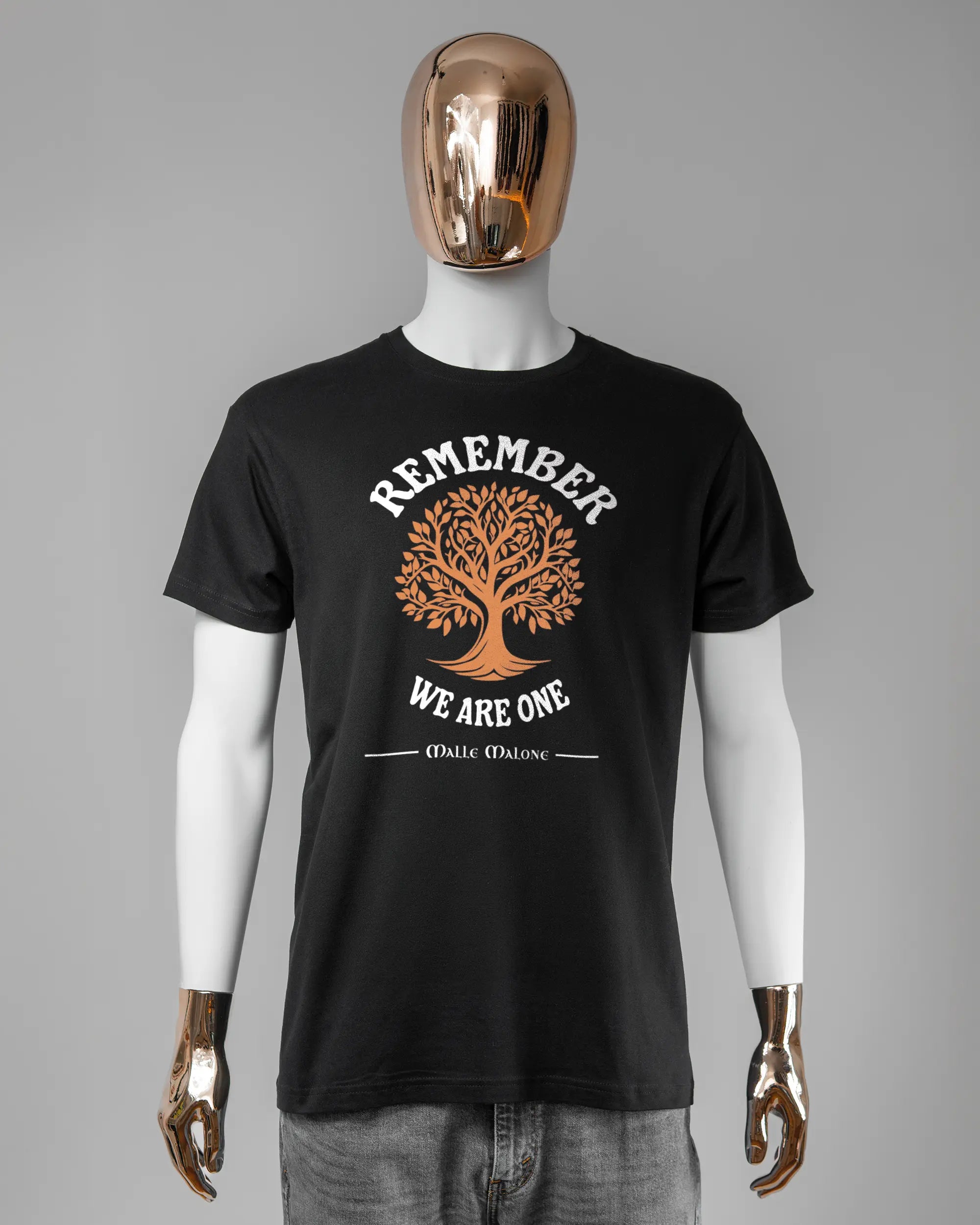 Vorderseite des Basic Unisex T-Shirt Soft von Maondo mit dem Design We are one in der Farbe Black und in der Größe L getragen von einer maskulinen Puppe