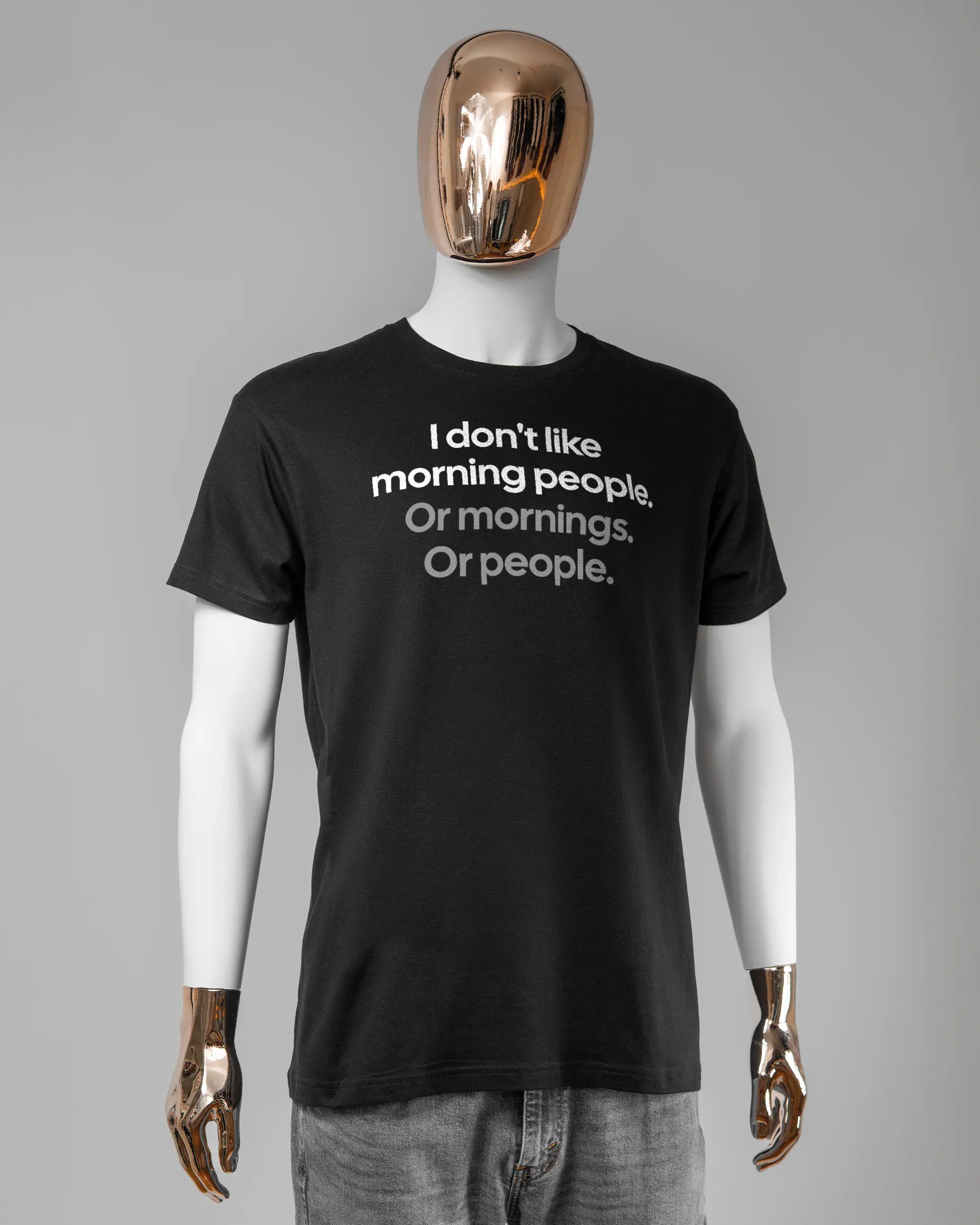 Vorderseite des Basic Unisex T-Shirt Soft von Maondo mit dem Design Morning Person in der Farbe Black und in der Größe L getragen von einer maskulinen Puppe