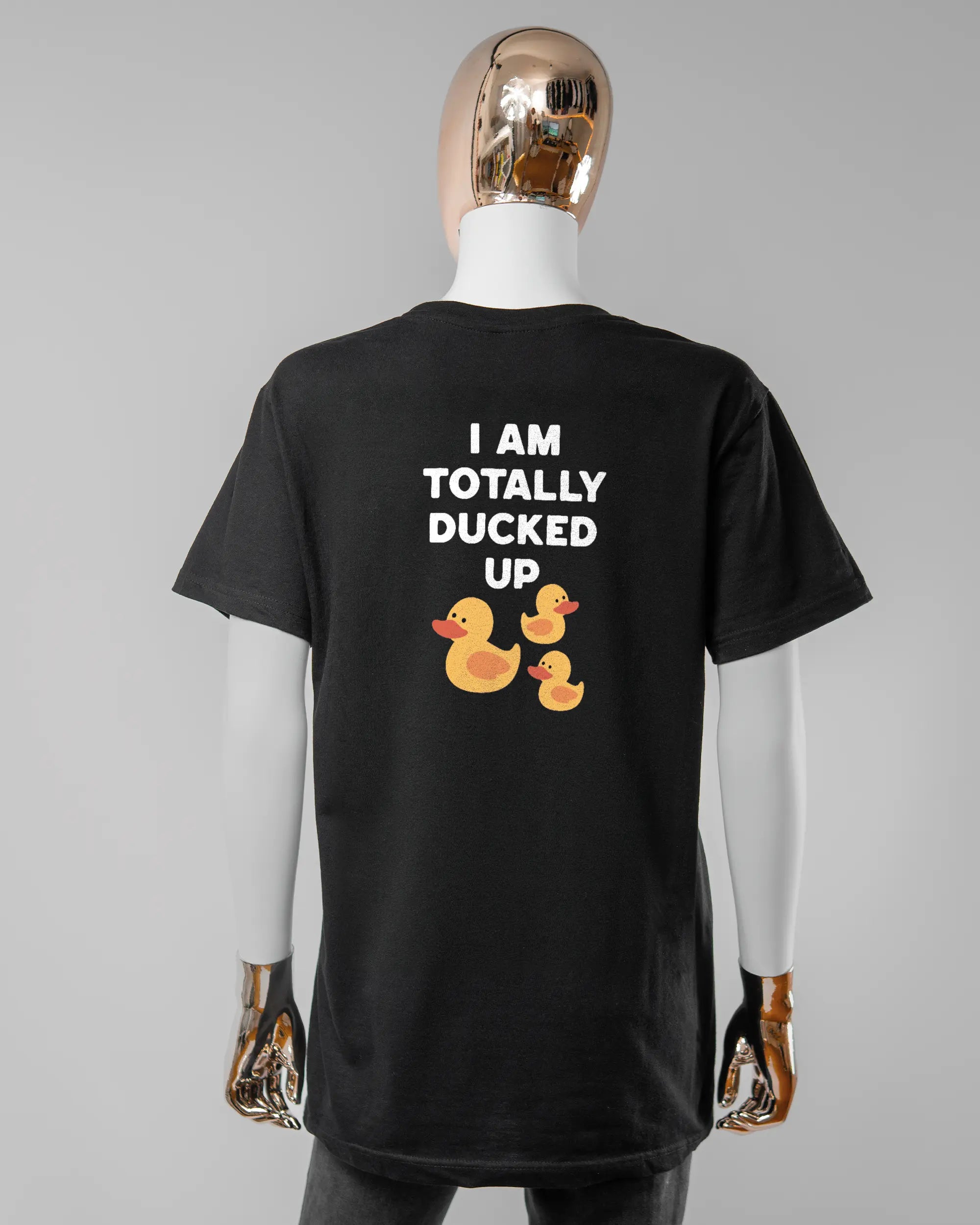 Rückseite des Basic Unisex T-Shirt Soft von Maondo mit dem Design Ducked Up in der Farbe Black und in der Größe S getragen von einer femininen Puppe