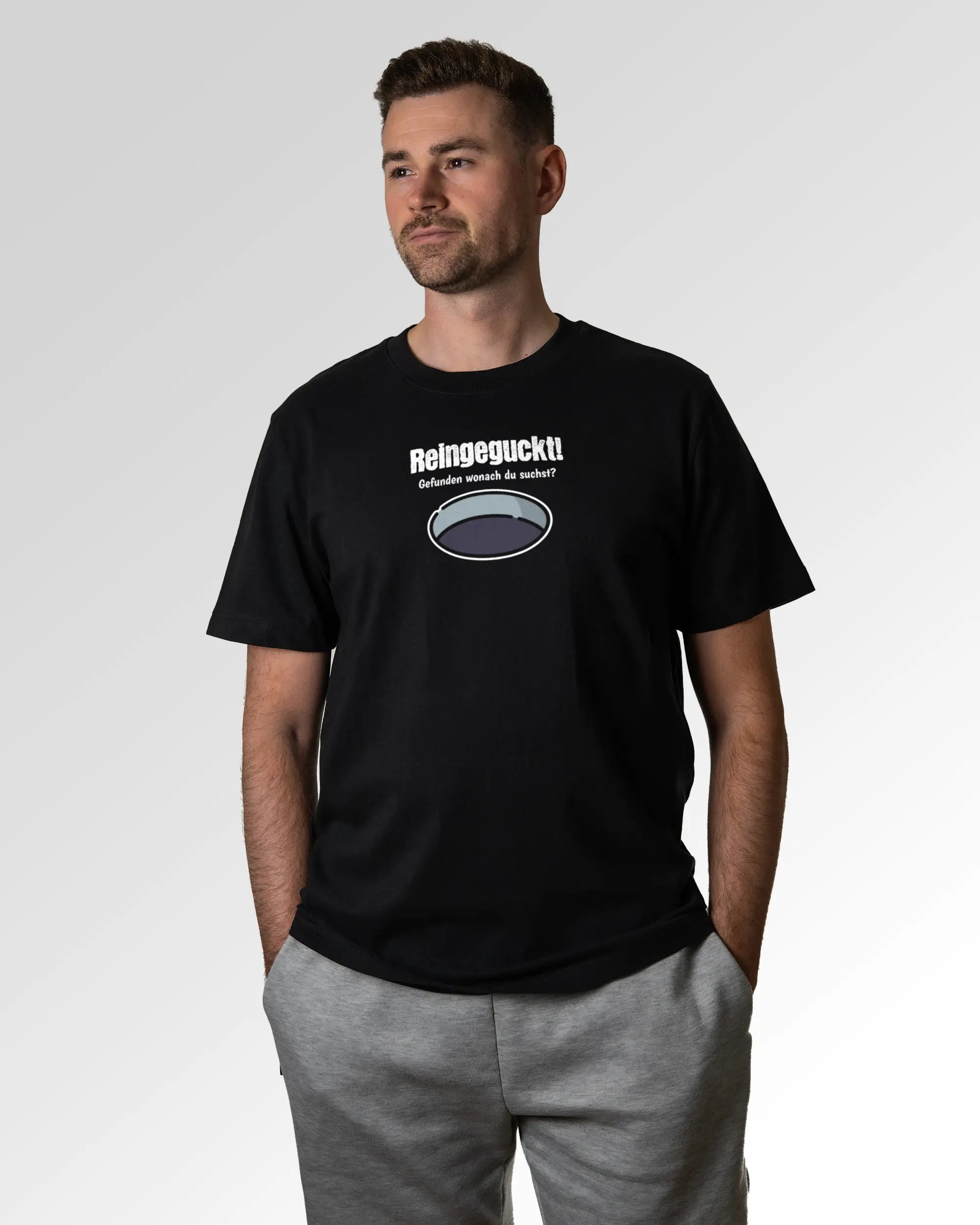 Primärer Modelshot der Druckseite des Organic Unisex T-Shirts von Maondo im Heavy Fit mit dem Design Reinglotzen in der Farbe Black