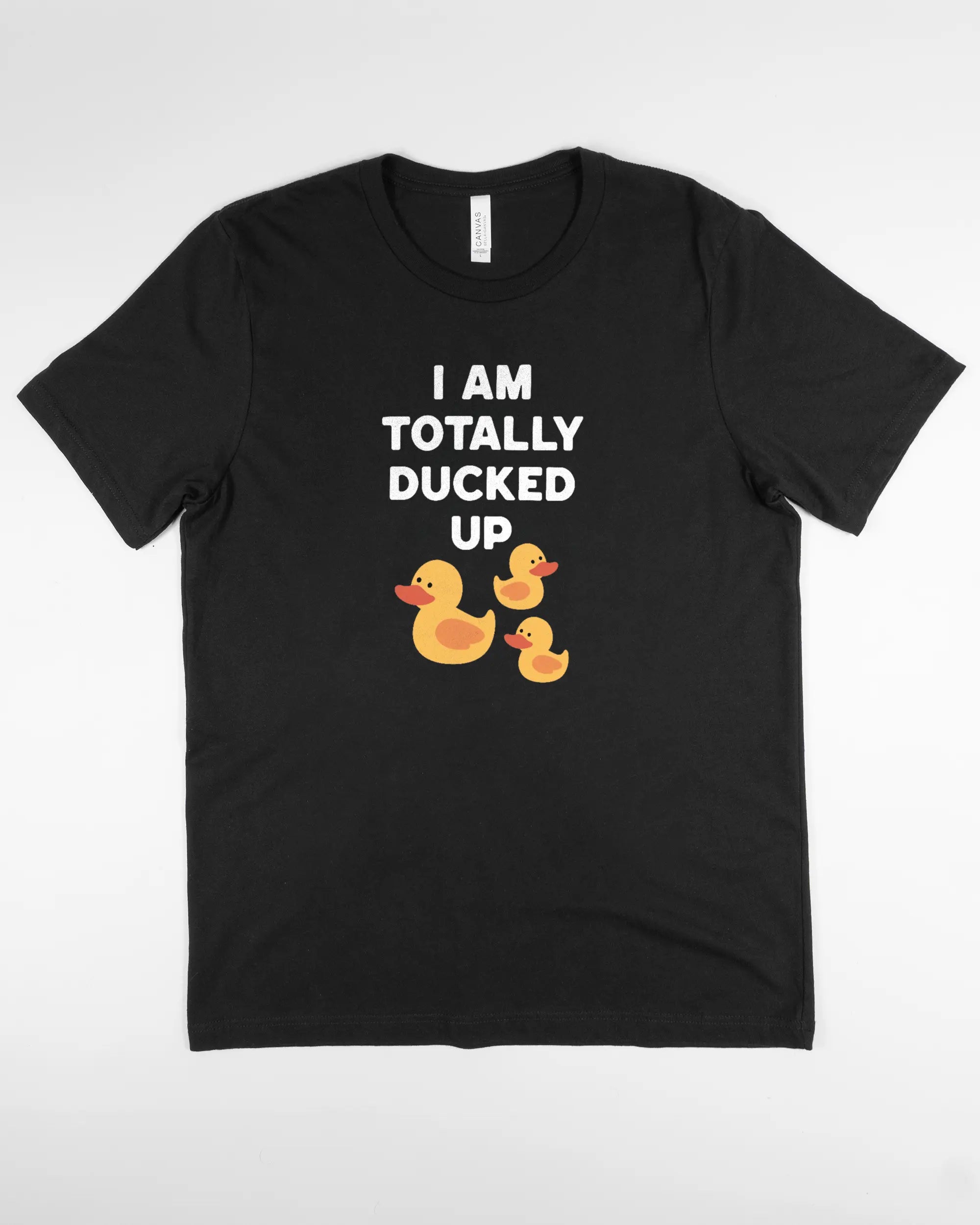 Vorderseite des Basic Unisex T-Shirt Light von Maondo mit dem Design Ducked Up in der Farbe Black und in der Größe L flach auf den Boden gelegt