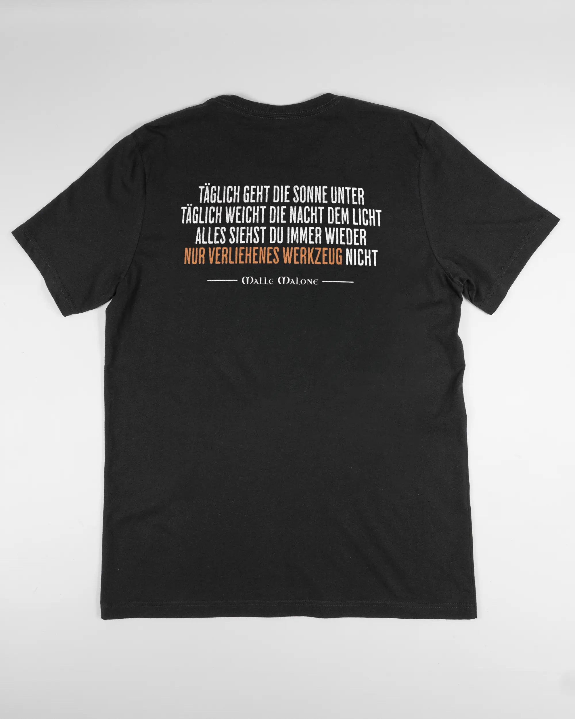 Rückseite des Basic Unisex T-Shirt Light von Maondo mit dem Design Wegzeug in der Farbe Black und in der Größe L flach auf den Boden gelegt