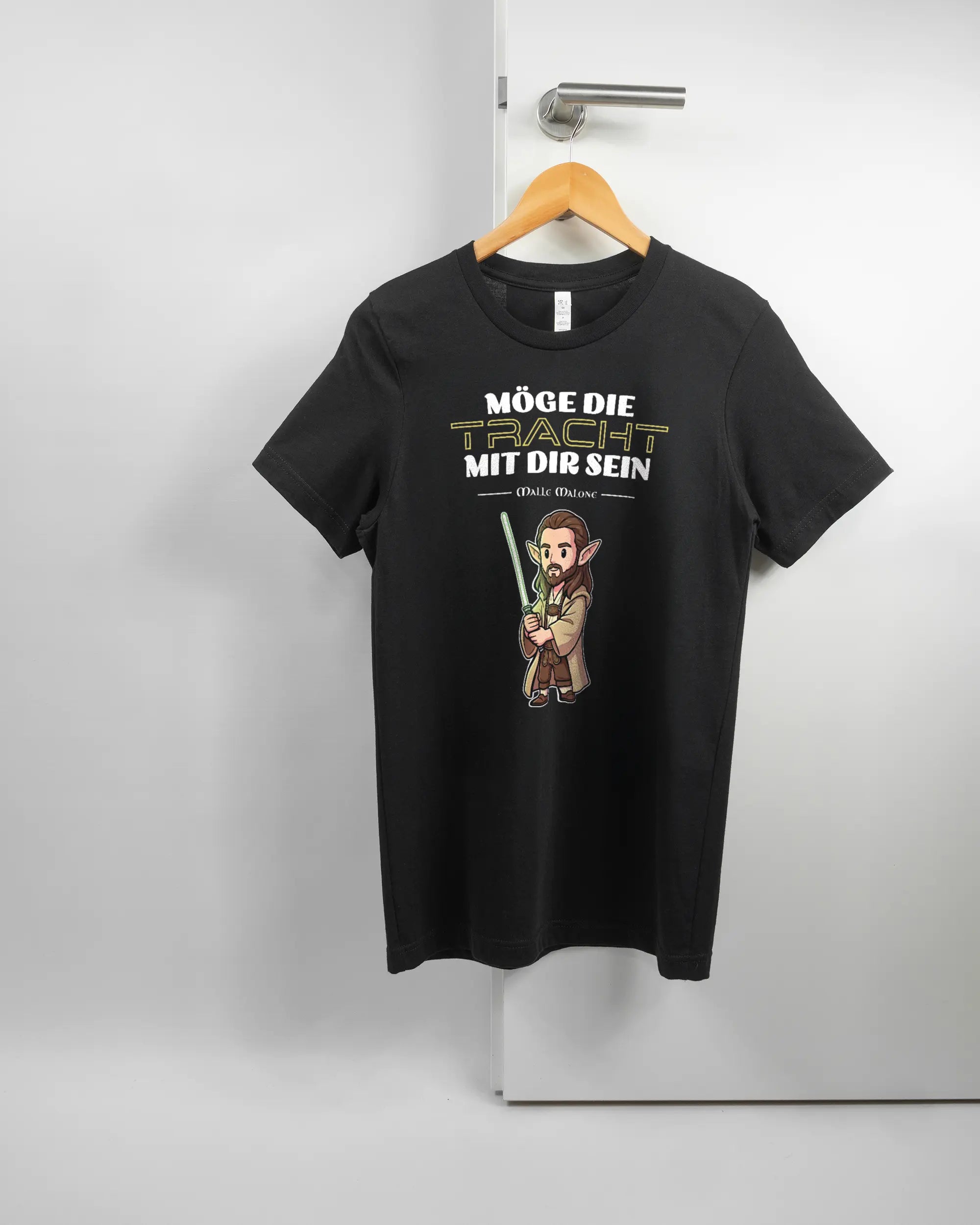 Vorderseite des Basic Unisex T-Shirt Light von Maondo mit dem Design Tracht mit dir in der Farbe Black und in der Größe S auf einem Bügel an der Türklinke aufgehängt