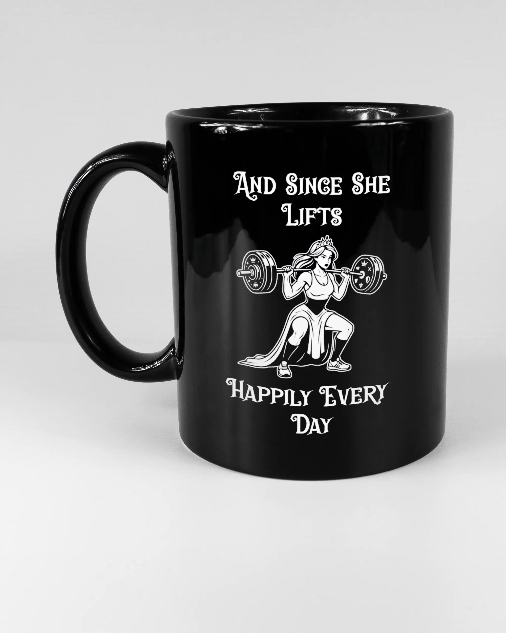 Titelbild, das die linke Seite der beidseitig bedruckten Keramiktasse von Maondo mit dem Design Princess Lift in der Farbe Black auf einem Holztisch zeigt