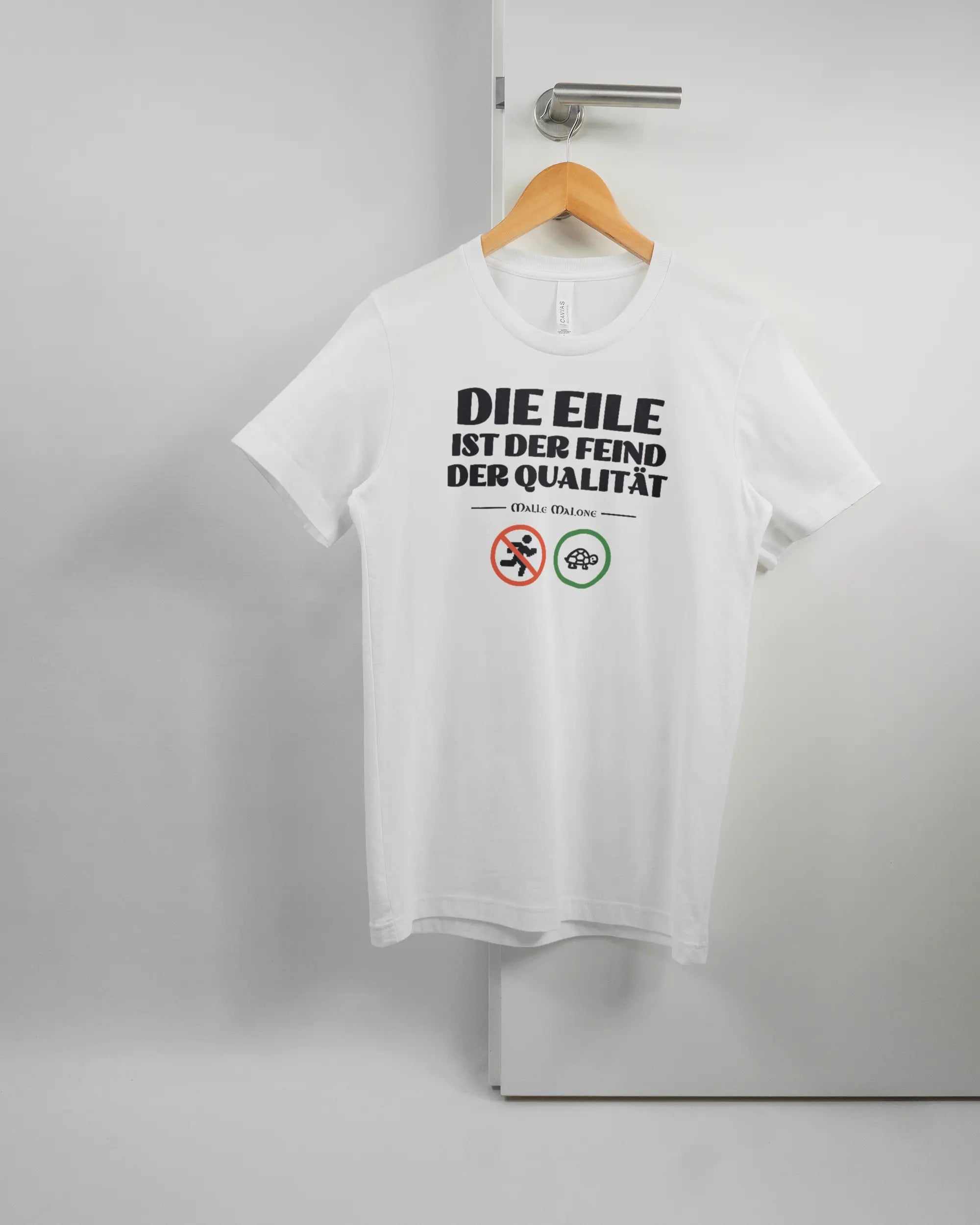 Vorderseite des Basic Unisex T-Shirt Light von Maondo mit dem Design Keine Eile in der Farbe White und in der Größe S auf einem Bügel an der Türklinke aufgehängt