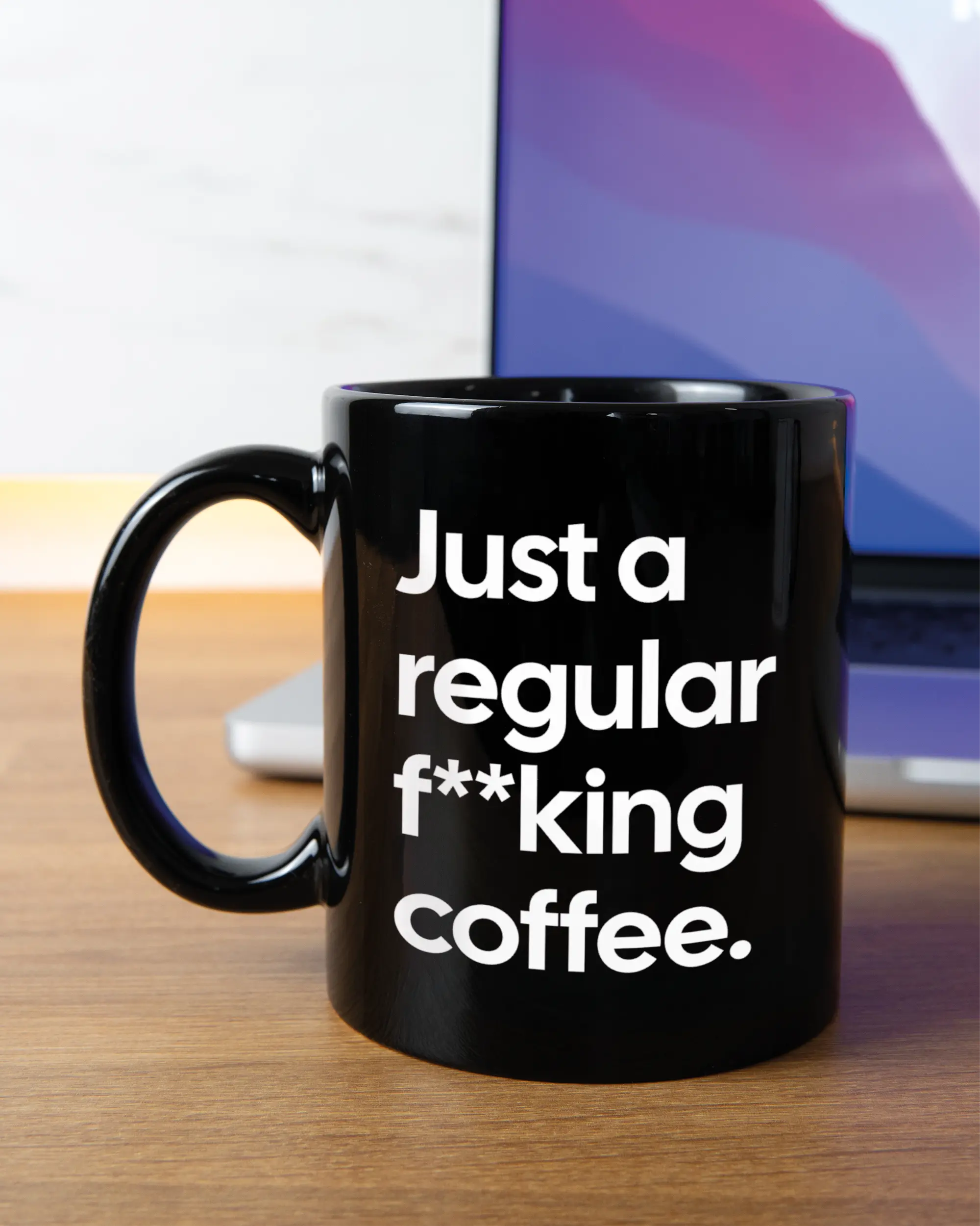 Homeoffice Aufnahme der linken Seite der beidseitig bedruckten Keramiktasse von Maondo mit dem Design Regular Coffee in der Farbe Black