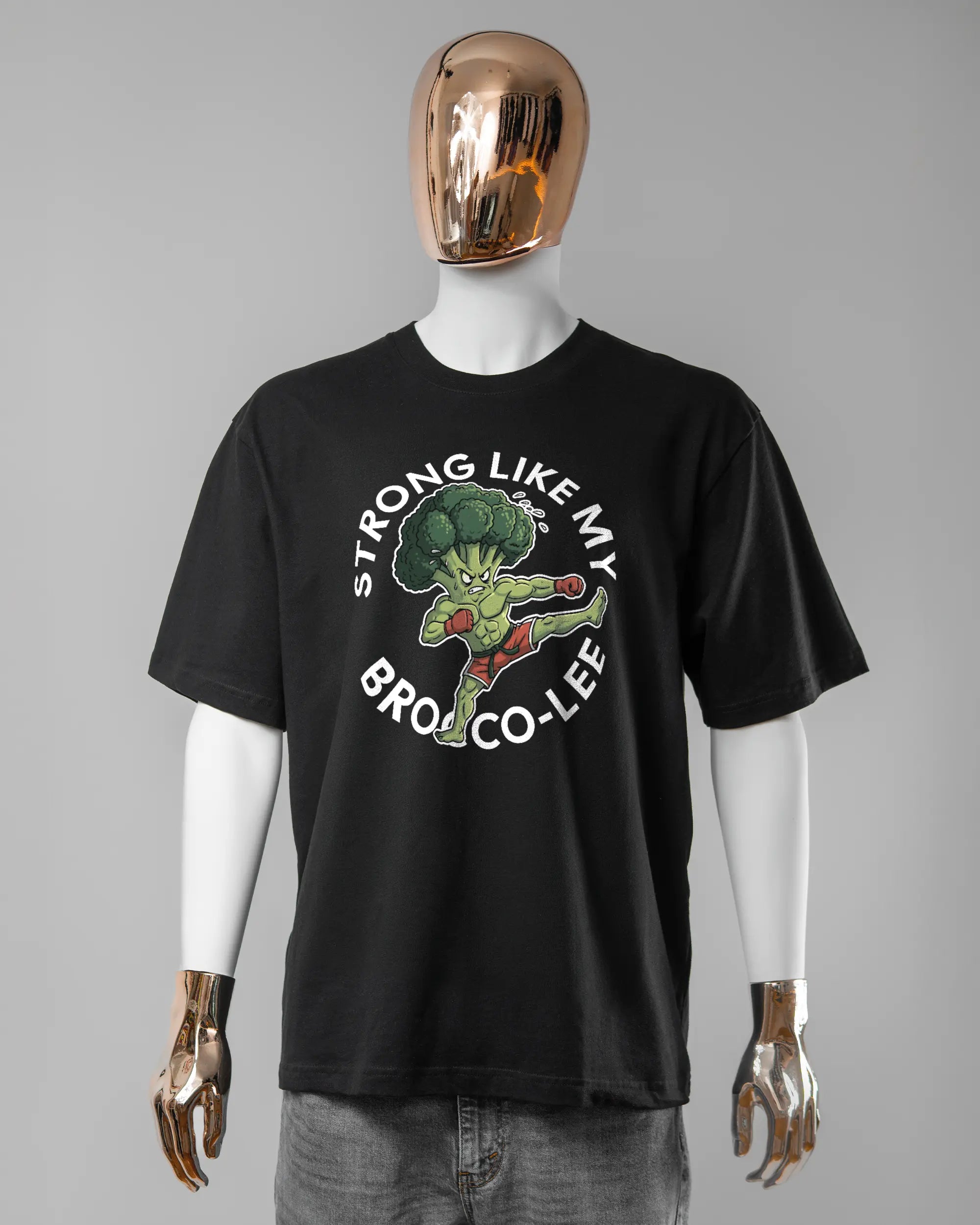 Vorderseite des Basic Unisex T-Shirt Oversized von Maondo mit dem Design Brocco-Lee in der Farbe Black und in der Größe L getragen von einer maskulinen Puppe