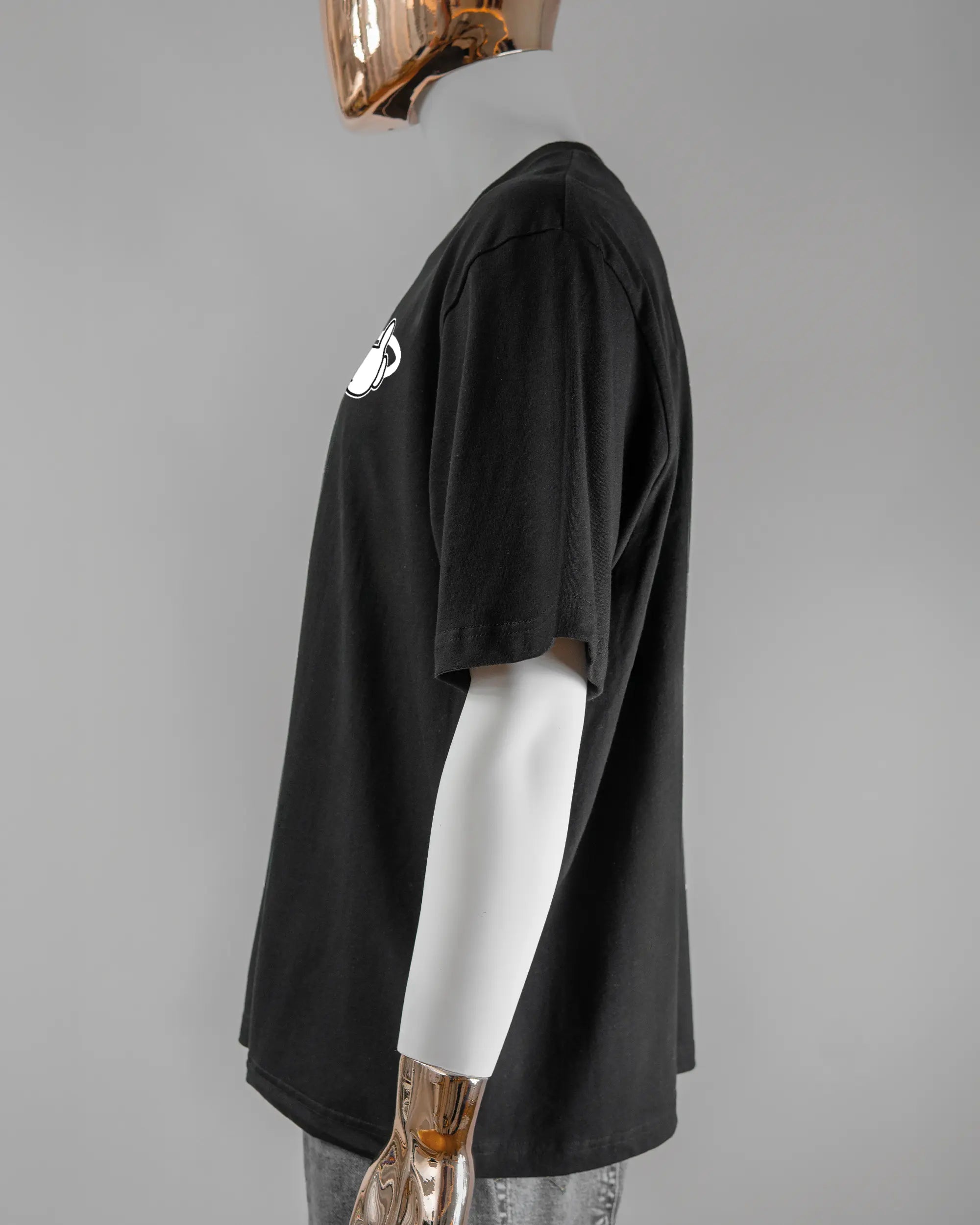 Seitenansicht des Basic Unisex T-Shirt Oversized von Maondo mit dem Design Fantastisch vorne in der Farbe Black und in der Größe L getragen von einer maskulinen Puppe