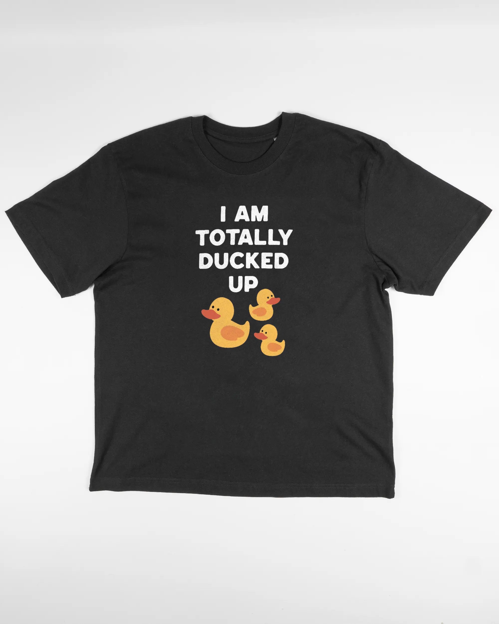 Vorderseite des Basic Unisex T-Shirt Oversized von Maondo mit dem Design Ducked Up in der Farbe Black und in der Größe S flach auf den Boden gelegt