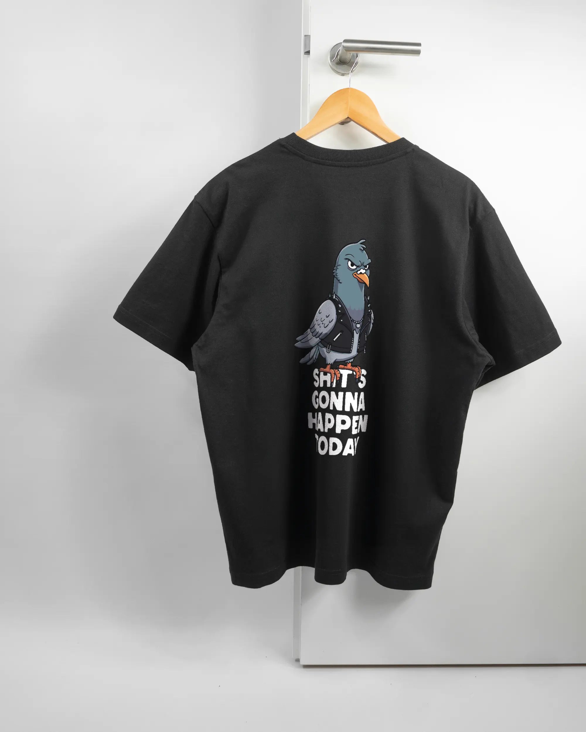Rückseite des Basic Unisex T-Shirt Oversized von Maondo mit dem Design Pigeon Pun in der Farbe Black und in der Größe S auf einem Bügel an der Türklinke aufgehängt