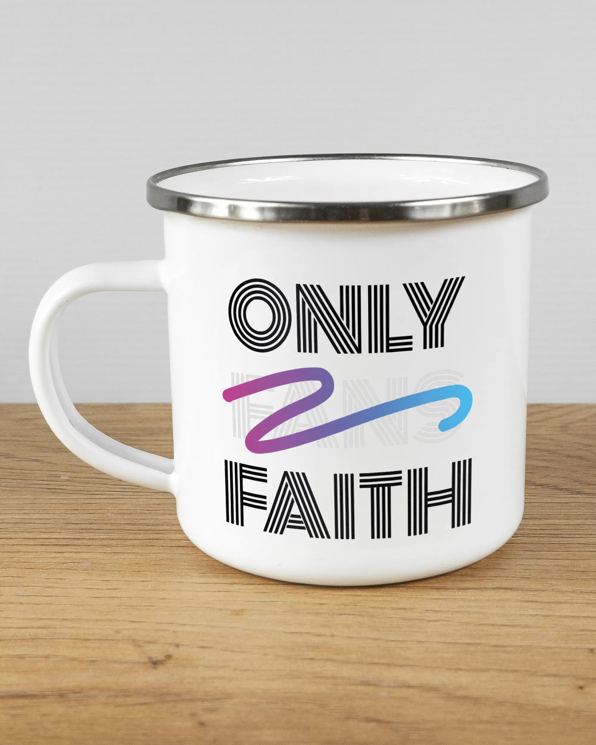 Titelbild, das die linke Seite der beidseitig bedruckten Emailletasse von Maondo mit dem Design Only Faith in der Farbe White-Silver auf einem Holztisch zeigt