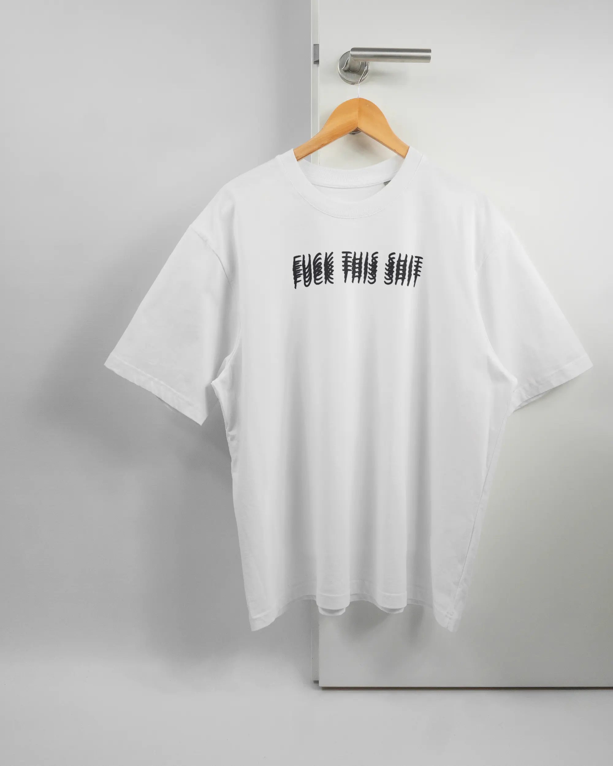 Vorderseite des Basic Unisex T-Shirt Oversized von Maondo mit dem Design Hidden Message in der Farbe White und in der Größe L auf einem Bügel an der Türklinke aufgehängt
