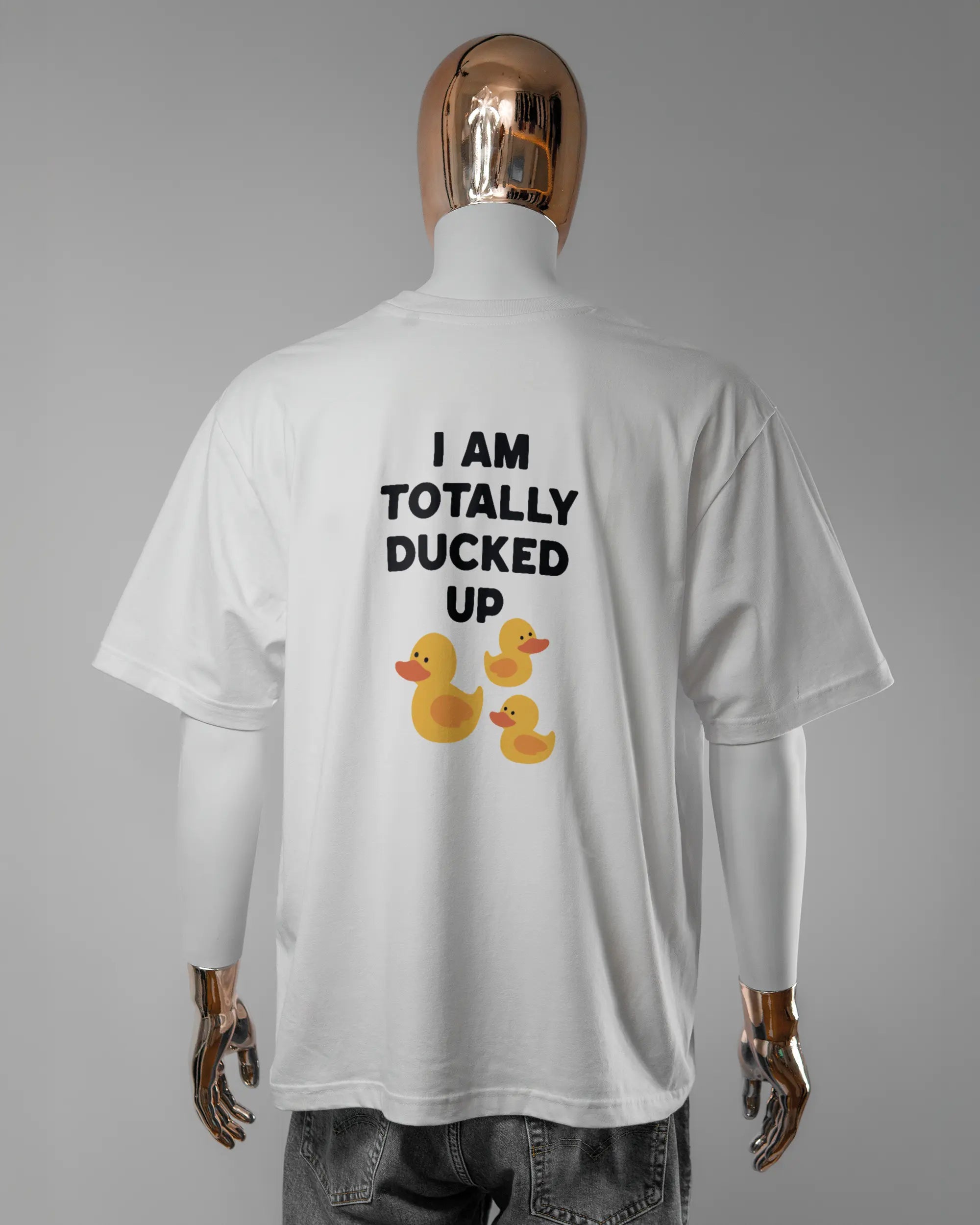Rückseite des Basic Unisex T-Shirt Oversized von Maondo mit dem Design Ducked Up in der Farbe White und in der Größe L getragen von einer maskulinen Puppe