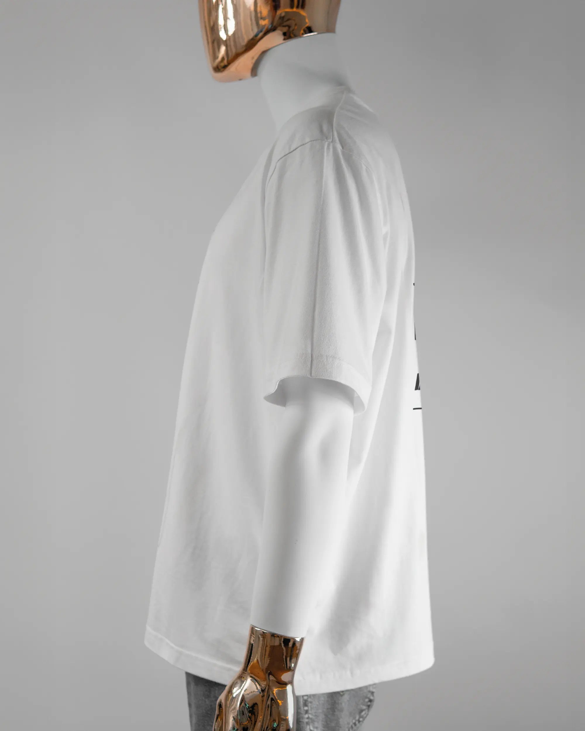 Seitenansicht des Basic Unisex T-Shirt Oversized von Maondo mit dem Design Holzarbeit hinten in der Farbe White und in der Größe L getragen von einer maskulinen Puppe