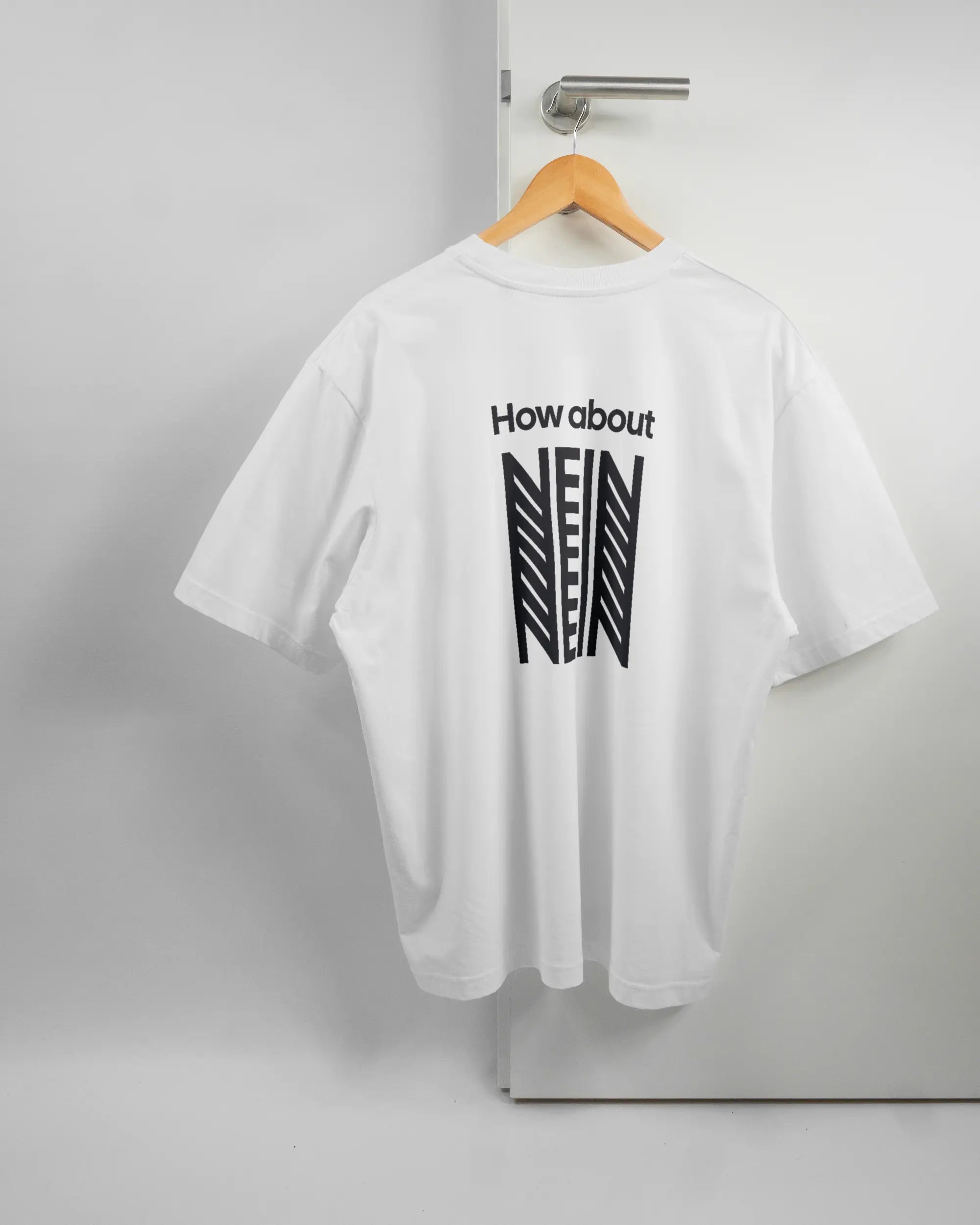 Rückseite des Basic Unisex T-Shirt Oversized von Maondo mit dem Design How about nein in der Farbe White und in der Größe L auf einem Bügel an der Türklinke aufgehängt