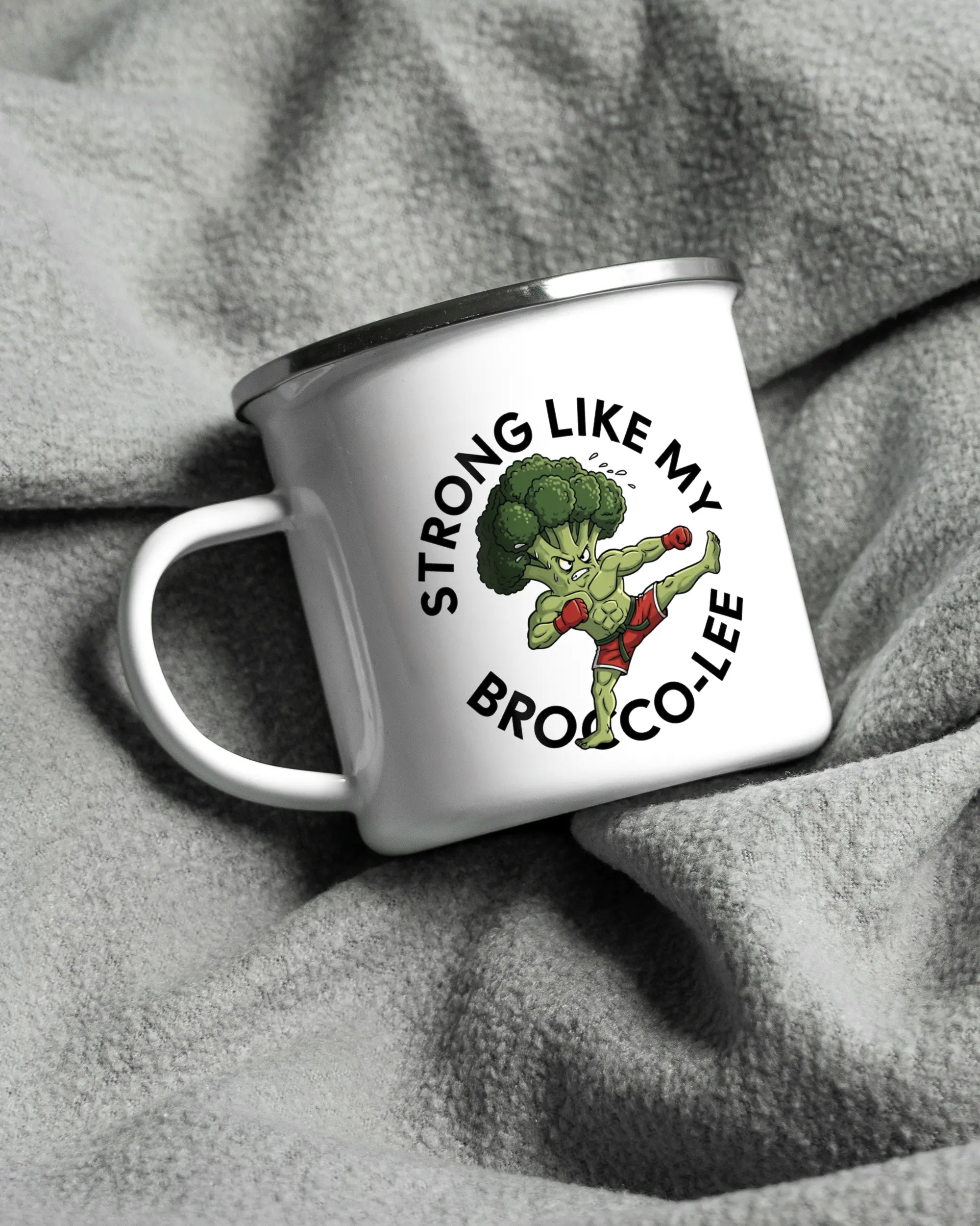 Aufnahme, die die linke Seite der beidseitig bedruckten Emailletasse von Maondo auf einer flauschigen Fließdecke mit dem Design White-Silver in der Farbe  zeigt