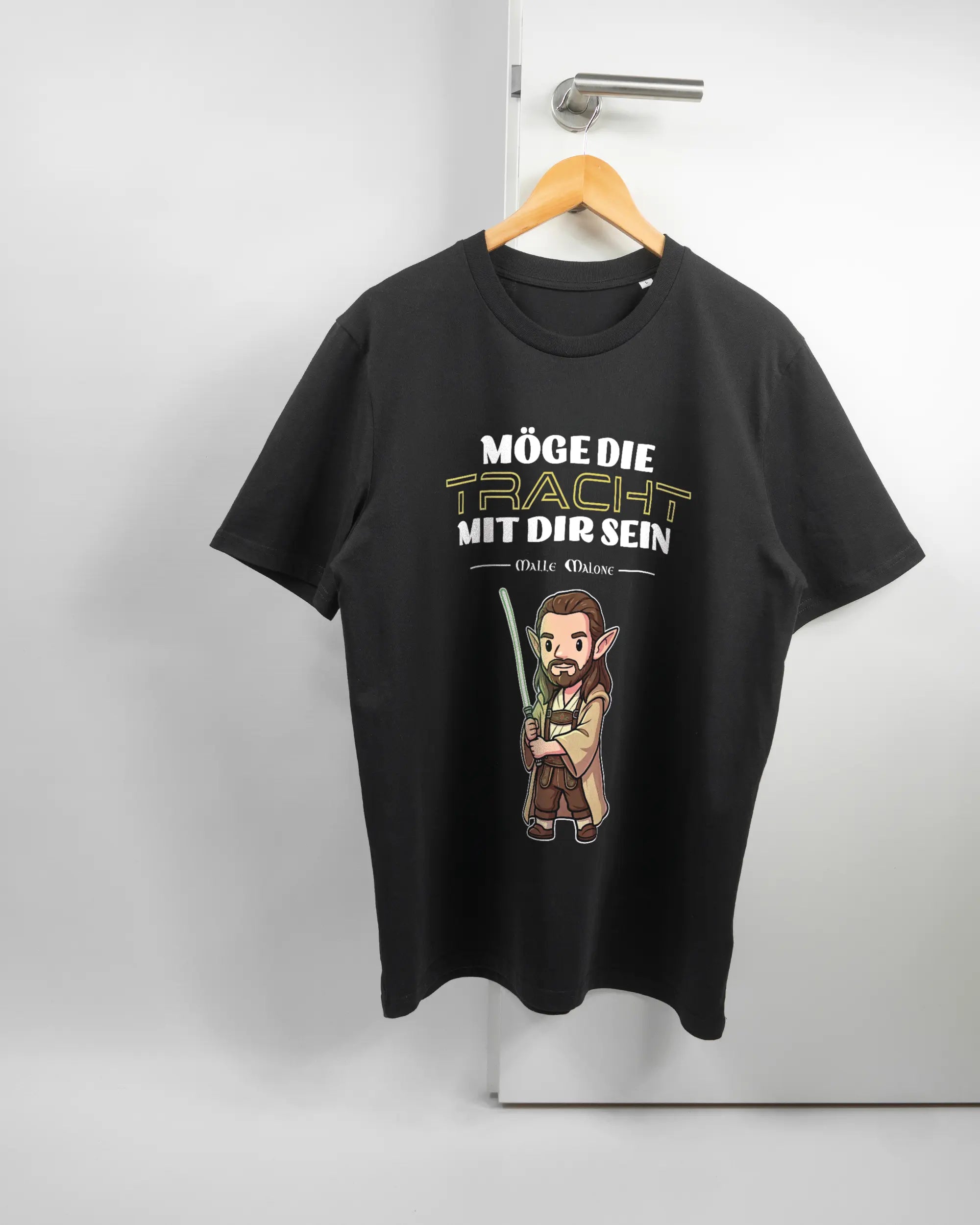 Vorderseite des Organic Unisex T-Shirt Casual von Maondo mit dem Design Tracht mit dir in der Farbe Black und in der Größe L auf einem Bügel an der Türklinke aufgehängt