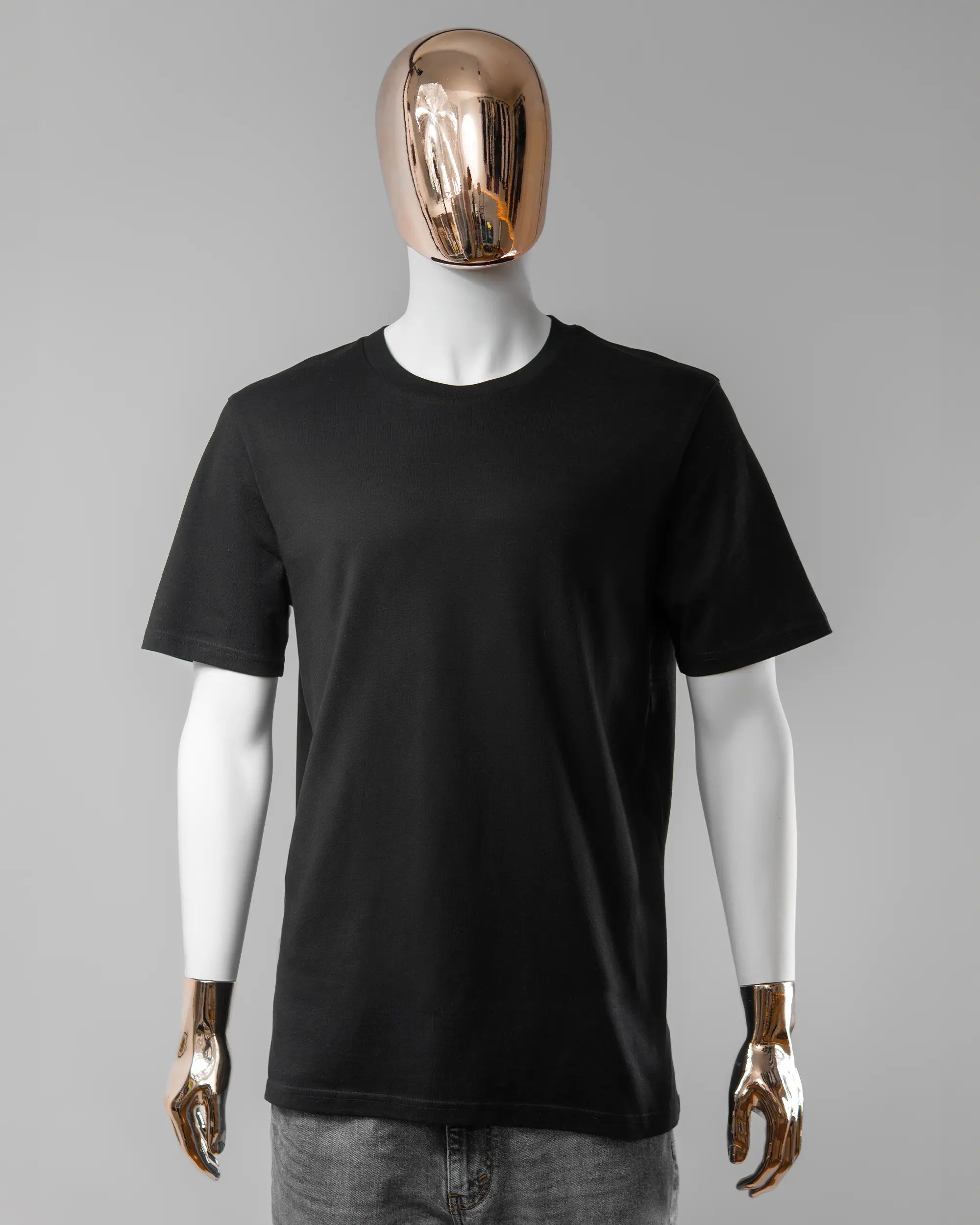 Vorderseite des Organic Unisex T-Shirt Casual von Maondo ohne Motiv in der Farbe Black und in der Größe L getragen von einer maskulinen Puppe