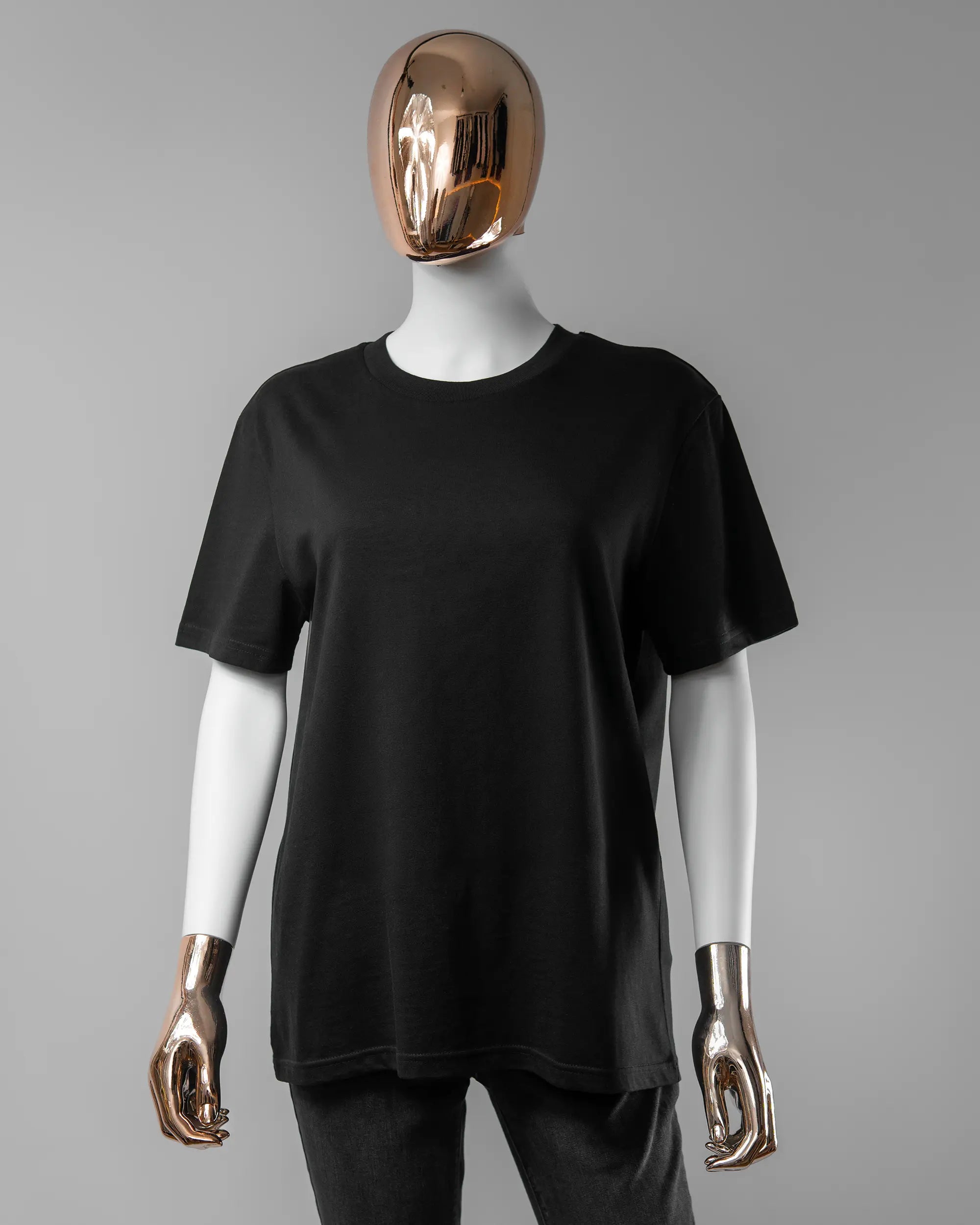 Vorderseite des Organic Unisex T-Shirt Casual von Maondo ohne Motiv in der Farbe Black und in der Größe S getragen von einer femininen Puppe