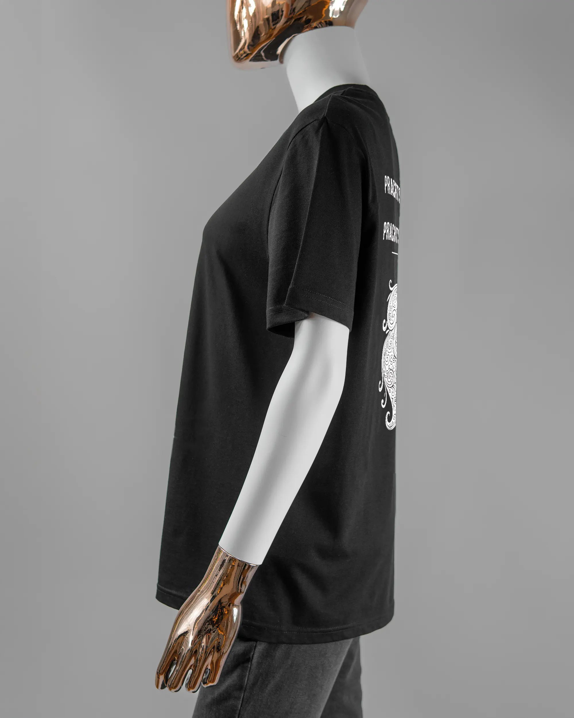 Seitenansicht des Organic Unisex T-Shirt Casual von Maondo mit dem Design Trachtentanz hinten in der Farbe Black und in der Größe S getragen von einer femininen Puppe