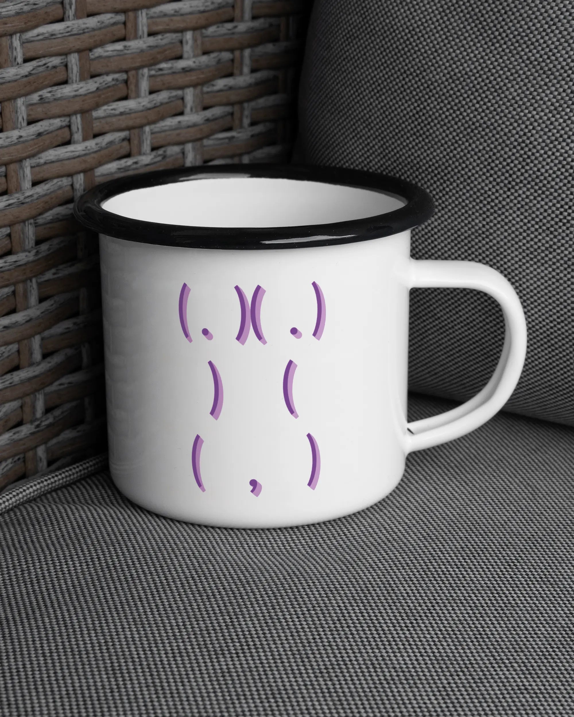 Ansicht der rechten Seite der beidseitig bedruckten Emailletasse von Maondo auf einem Balkonmöbel bzw. Campingstuhl mit dem Design Body Language in der Farbe White-Black