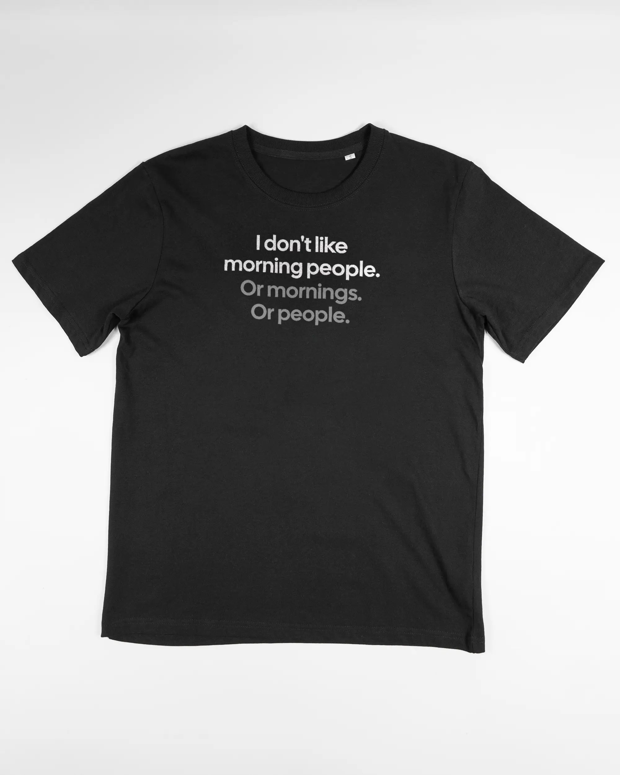 Vorderseite des Organic Unisex T-Shirt Relaxed von Maondo mit dem Design Morning Person in der Farbe Black und in der Größe S flach auf den Boden gelegt