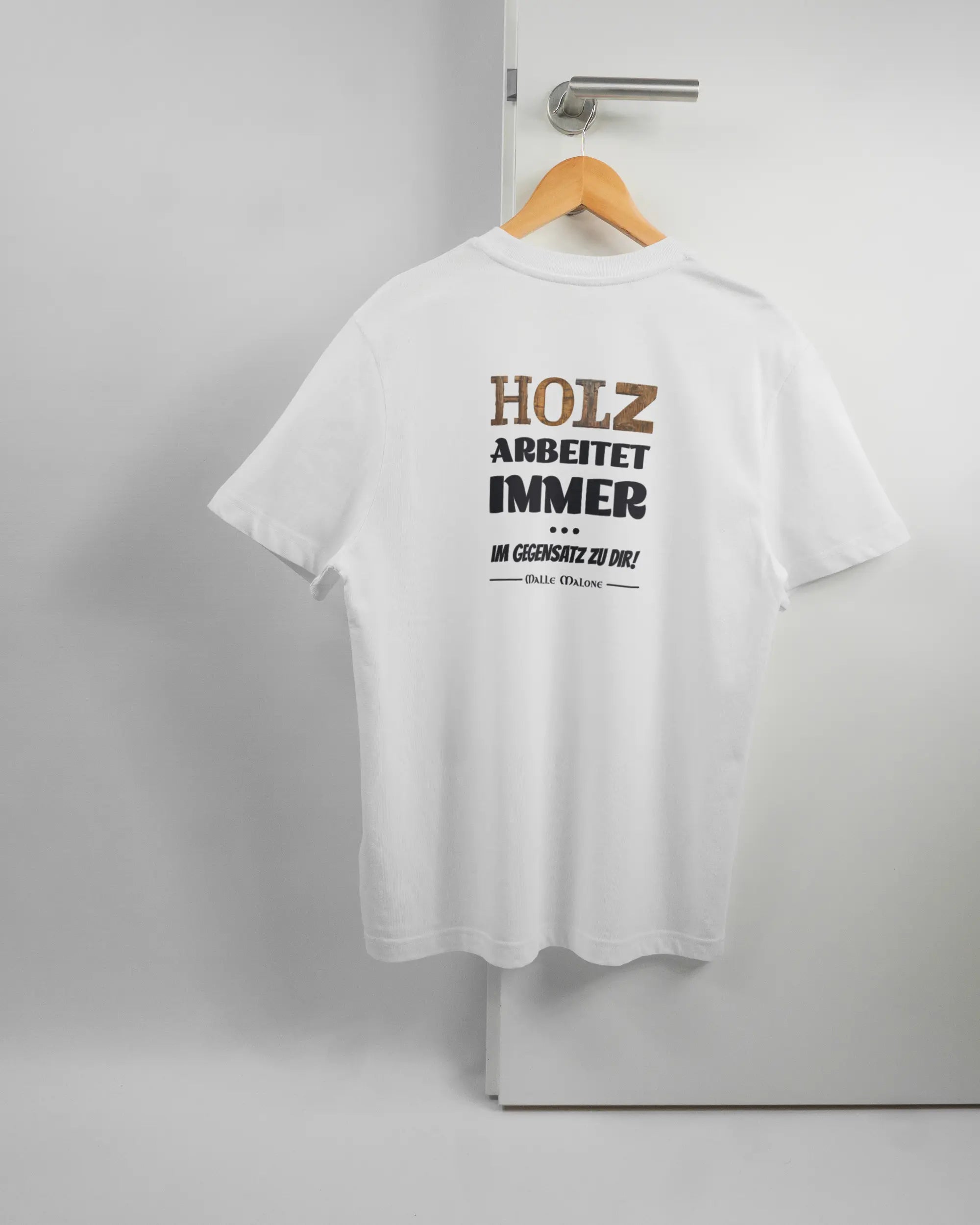 Rückseite des Organic Unisex T-Shirt Relaxed von Maondo mit dem Design Holzarbeit in der Farbe White und in der Größe S auf einem Bügel an der Türklinke aufgehängt