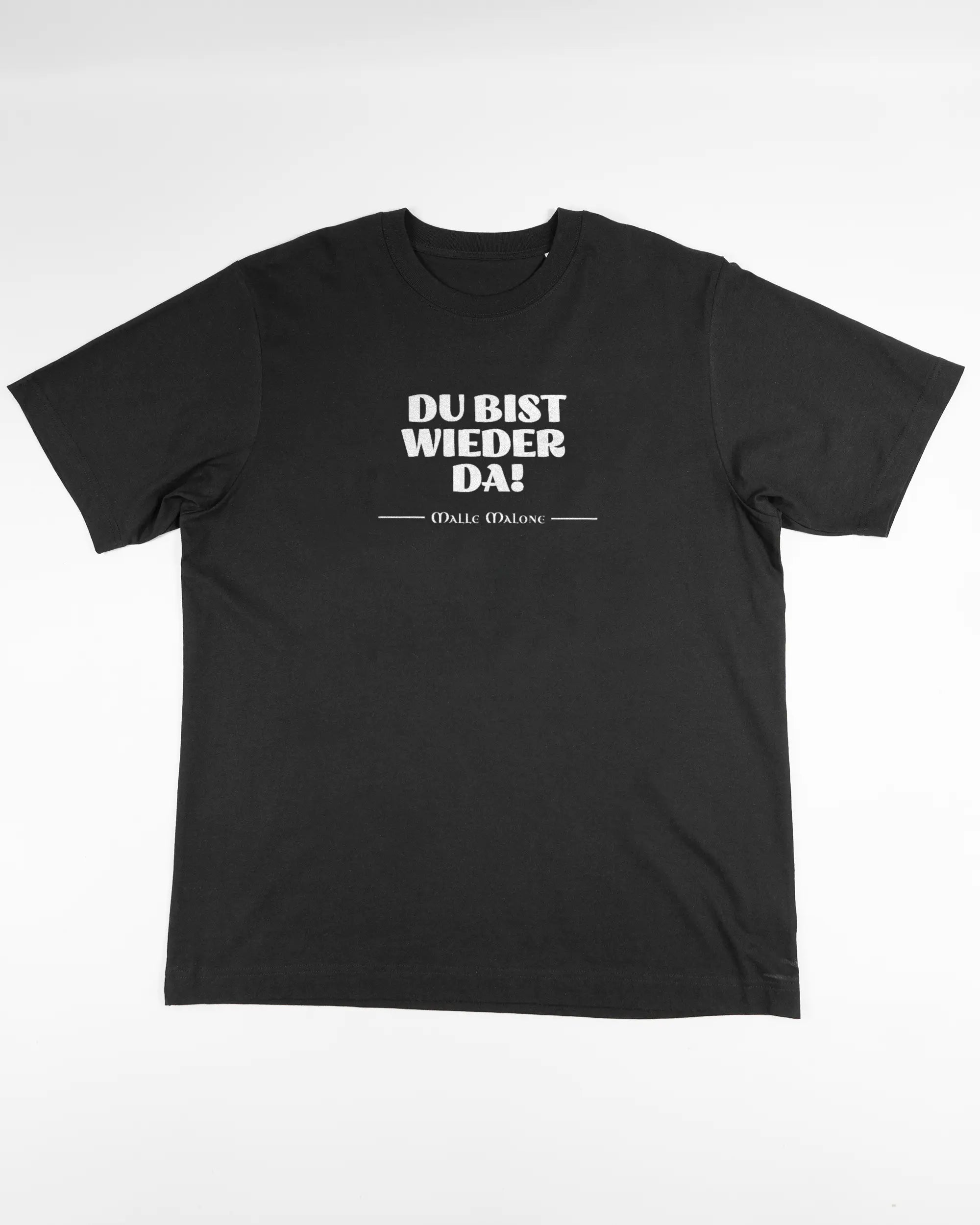 Vorderseite des Organic Unisex T-Shirt Heavy Oversized von Maondo mit dem Design Wieder da in der Farbe Black und in der Größe L flach auf den Boden gelegt