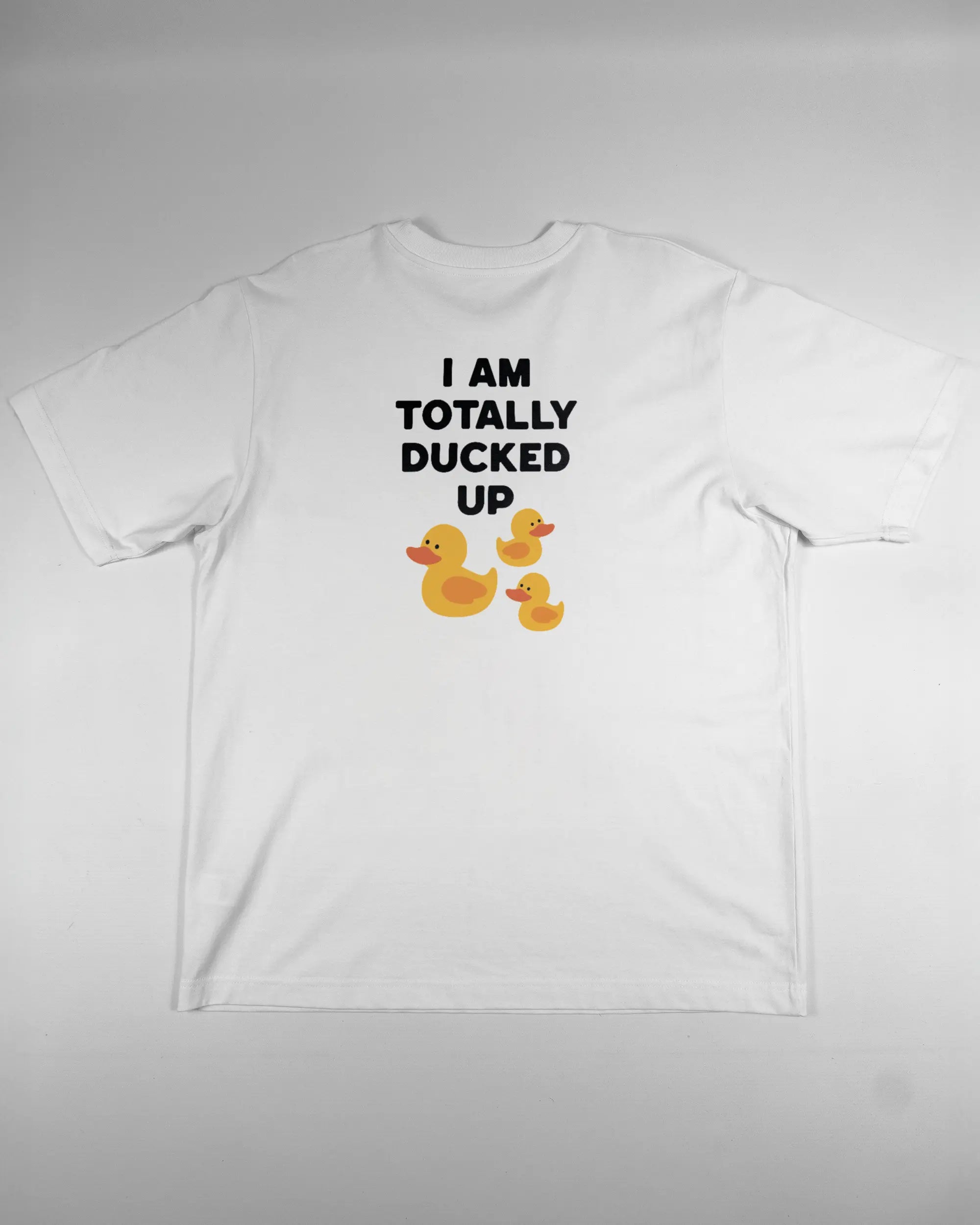 Rückseite des Organic Unisex T-Shirt Heavy Oversized von Maondo mit dem Design Ducked Up in der Farbe White und in der Größe L flach auf den Boden gelegt