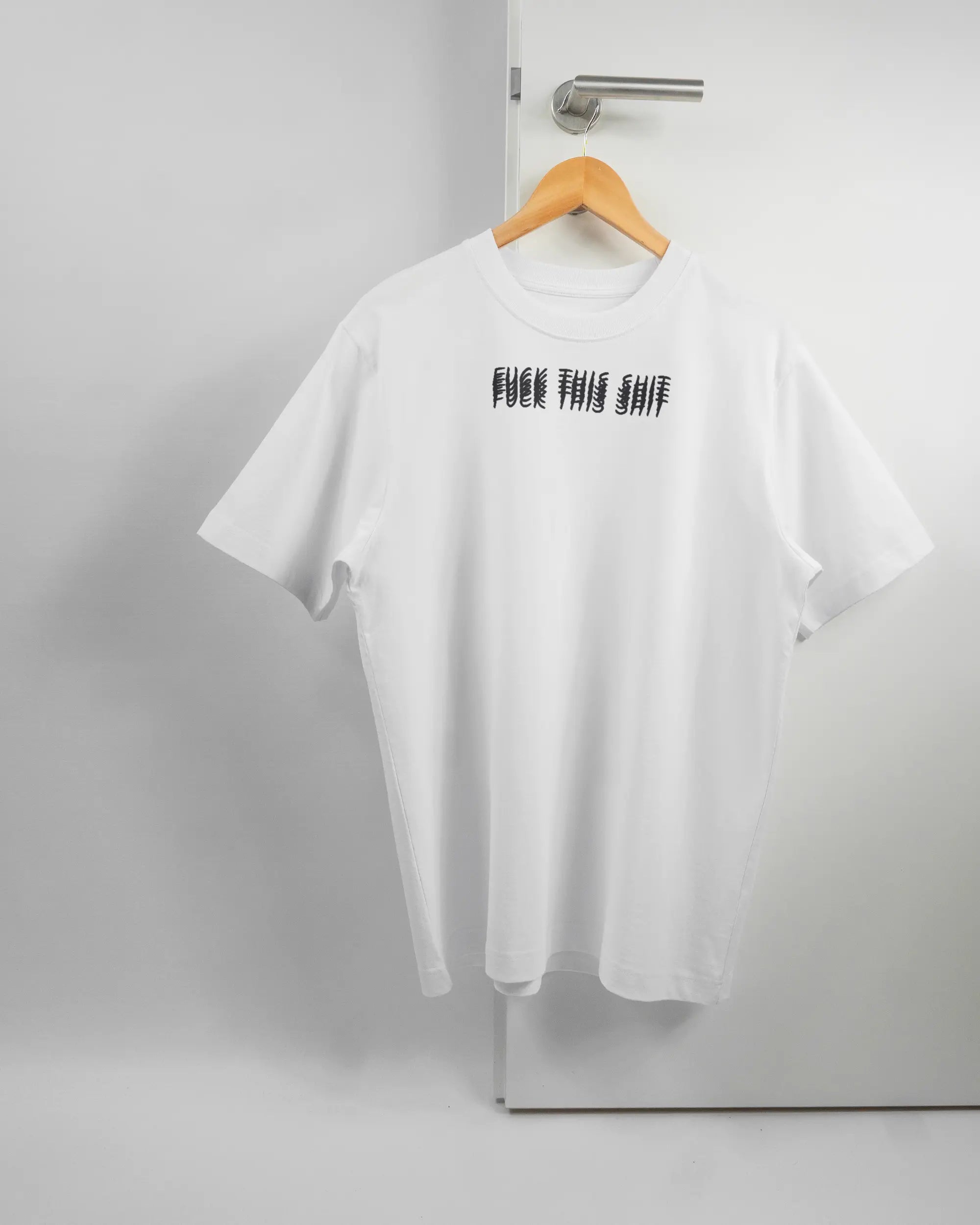 Vorderseite des Organic Unisex T-Shirt Heavy Oversized von Maondo mit dem Design Hidden Message in der Farbe White und in der Größe S auf einem Bügel an der Türklinke aufgehängt